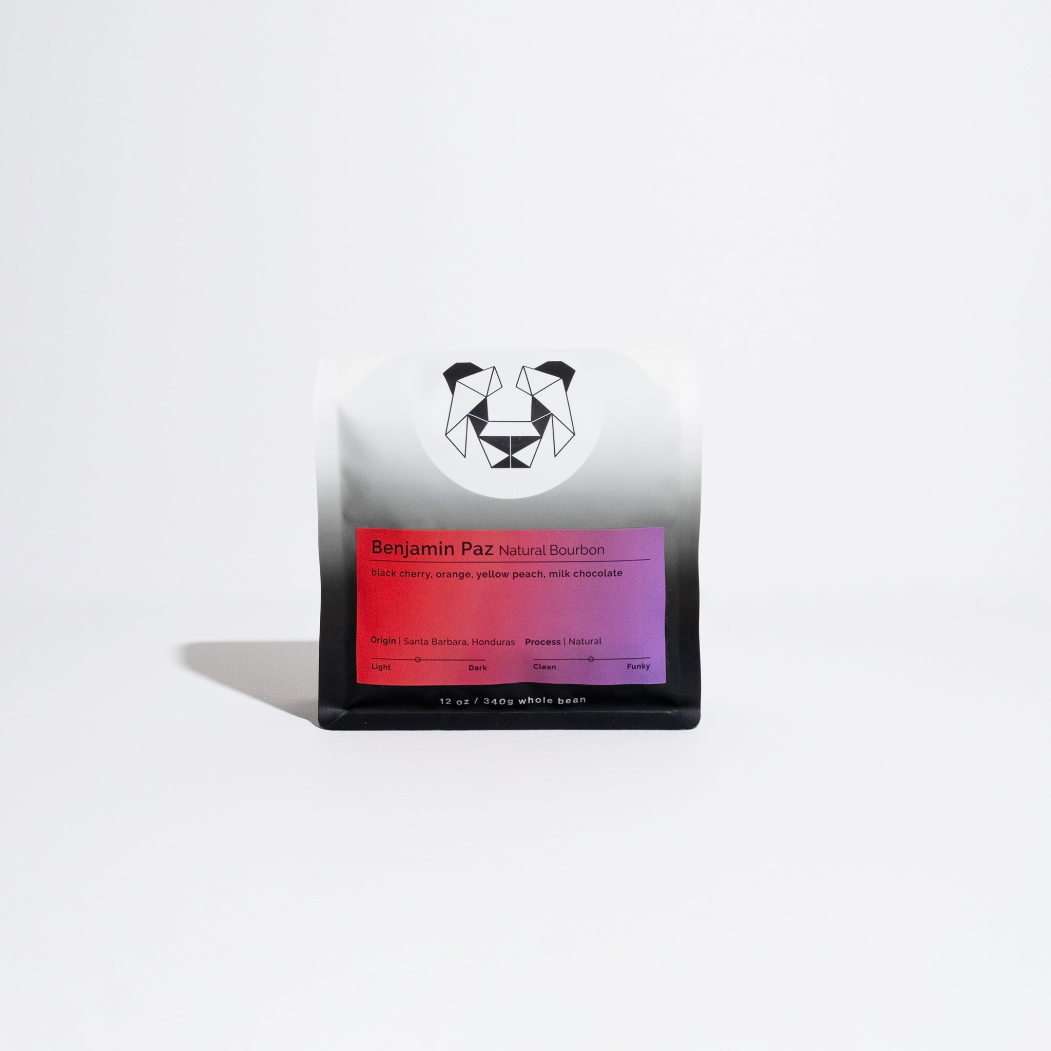 Benjamin Paz Natural Bourbon 12 oz whole-bean coffee from Honduras, featuring notes of black cherry, orange, and milk chocolate. Geometric panda logo on packaging.