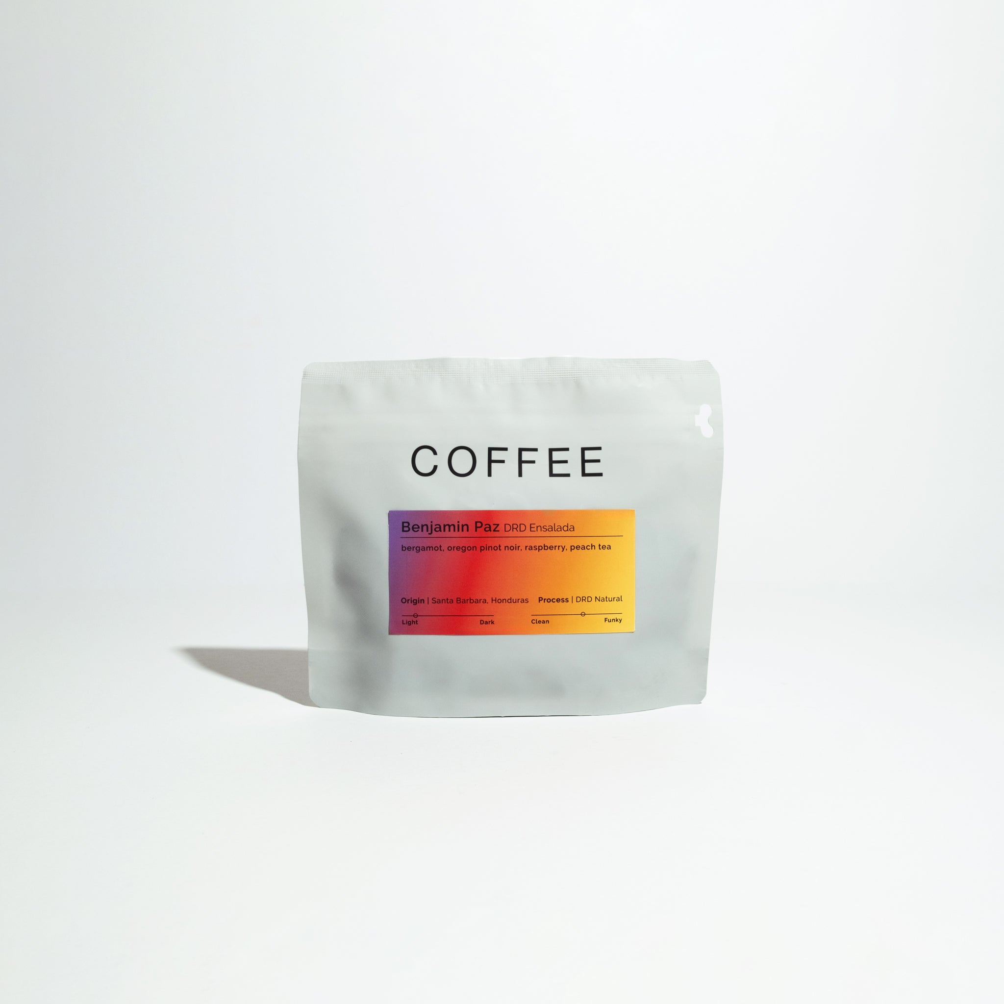Resealable pouch labeled “COFFEE” featuring “Benjamin Paz DRD Ensalada” with tasting notes: bergamot, raspberry, peach tea; origin: Santa Barbara, Honduras.