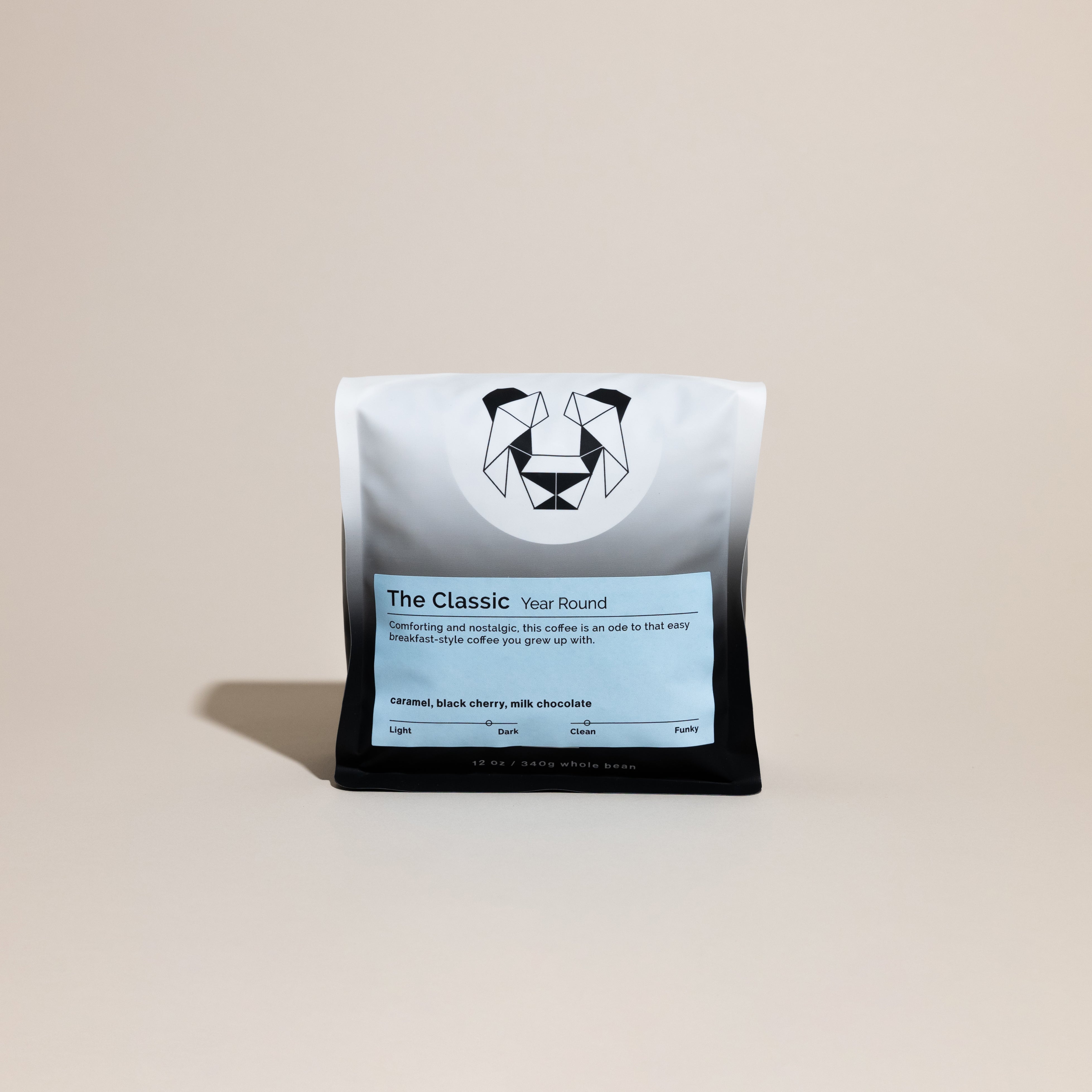 A bag of coffee on a cream backdrop with the words, "The Classic year round coffee" on it. The label has notes of caramel, black cherry, and milk chocolate.