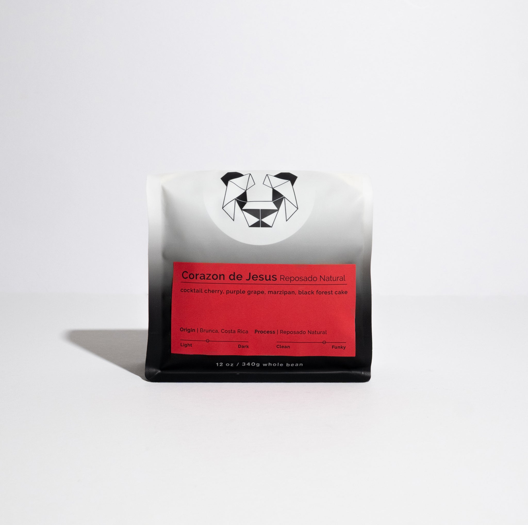 Corazon de Jesus – Reposado Natural whole-bean coffee bag with red label, featuring tasting notes and origin details from Brunca, Costa Rica, and geometric animal logo.