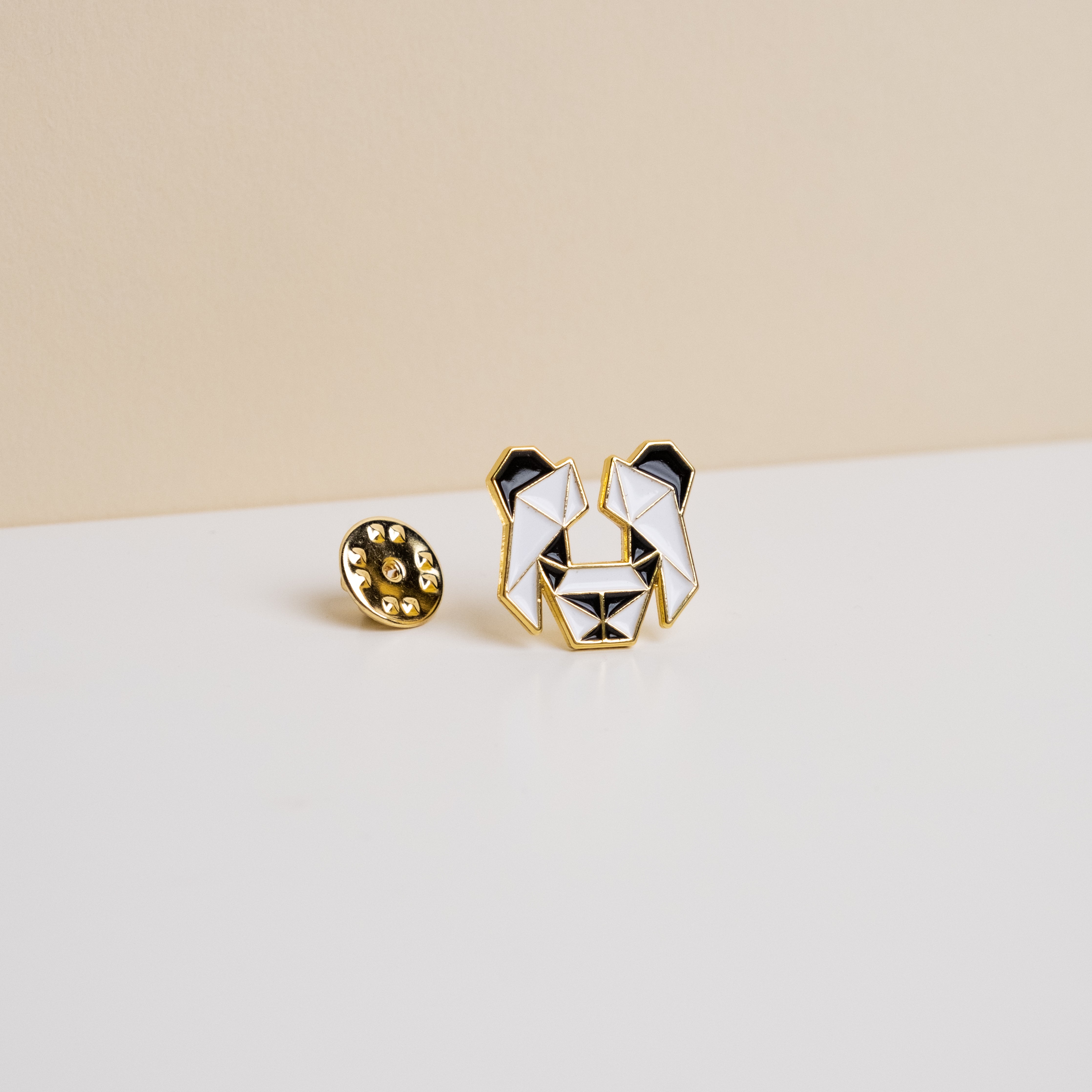 Enamel Panda Pin featuring a classic panda logo with gold accents and backing, approximately the size of a quarter.
