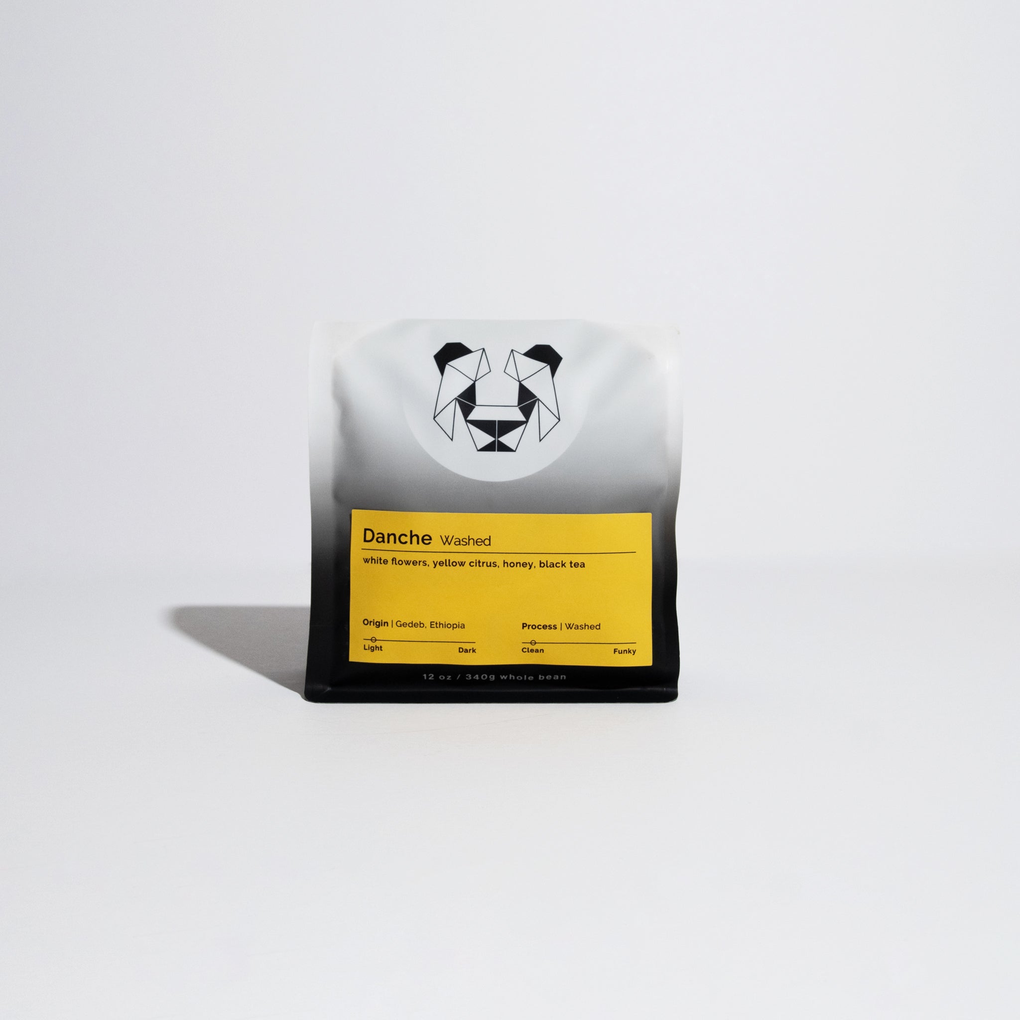 Danche Washed whole-bean coffee, 12 oz bag, featuring a yellow label with tasting notes and a geometric animal logo, from Gedeb, Ethiopia.