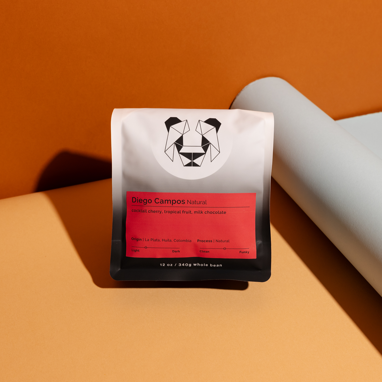 Diego Campos - Natural coffee packaging with vibrant design, highlighting its tropical fruit notes and smooth finish from La Plata, Colombia. Featured producer: 2021 World Barista Champion.