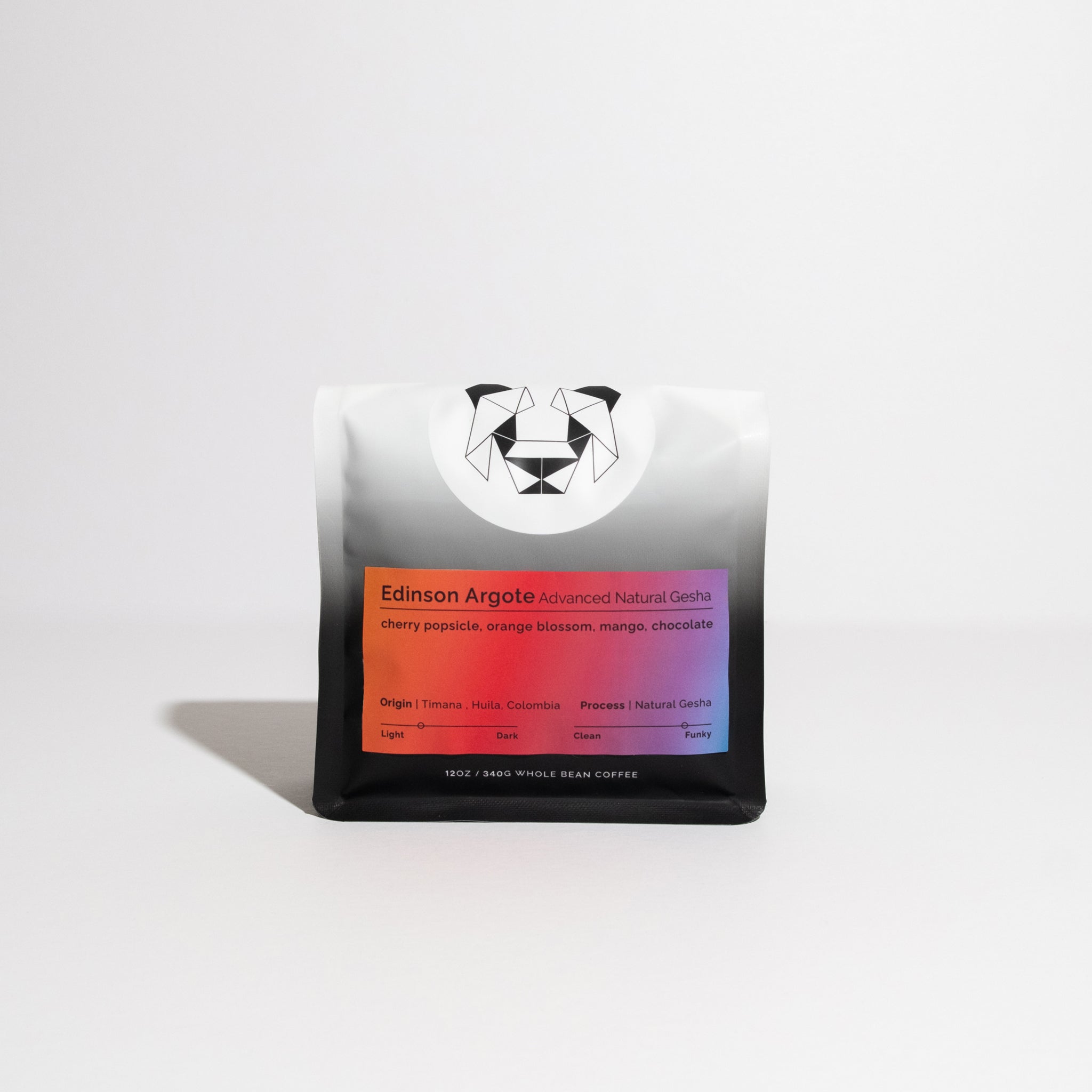 Whole-bean coffee bag labeled Edinson Argote – Advanced Natural Gesha, featuring tasting notes of cherry popsicle, orange blossom, mango, and chocolate; 12 oz weight.