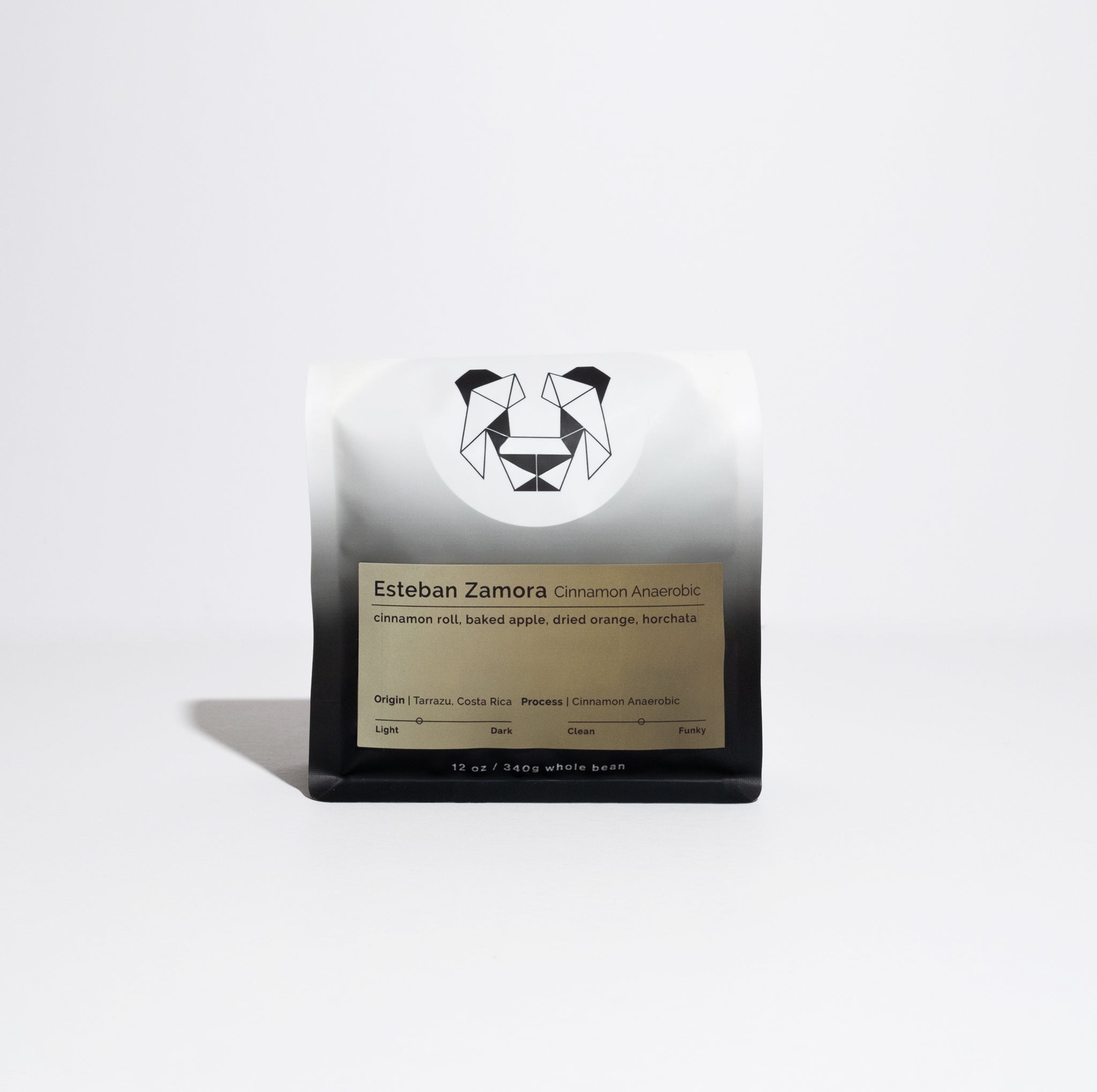 12 oz bag of Esteban Zamora Cinnamon Anaerobic coffee, featuring a geometric animal logo and gold label detailing origin, tasting notes, and processing method.