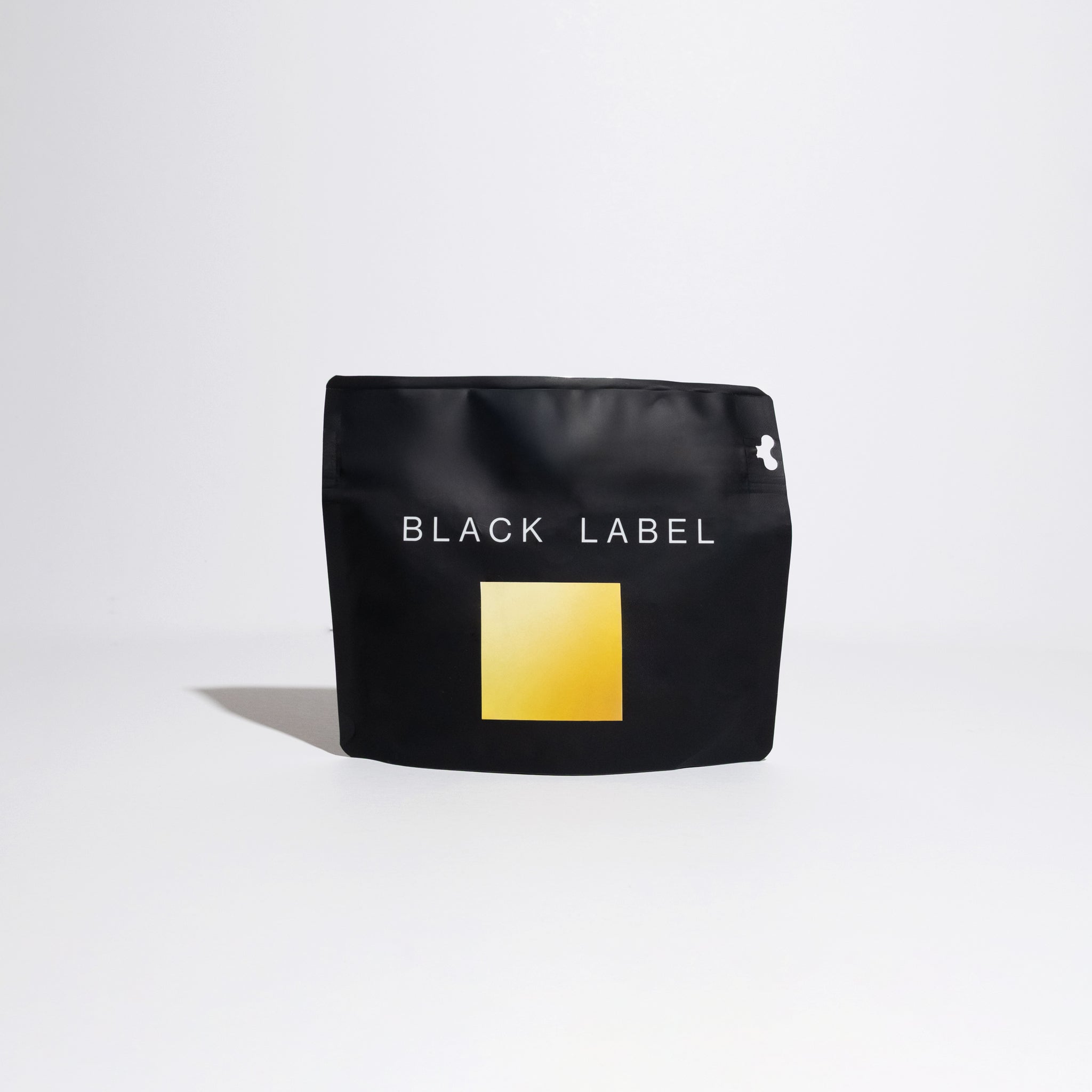 Finca Deborah - Terroir Gesha matte-black pouch with BLACK LABEL and yellow graphic, representing Jamison Savage's specialty coffee from Panama's high-altitude cloud forest.