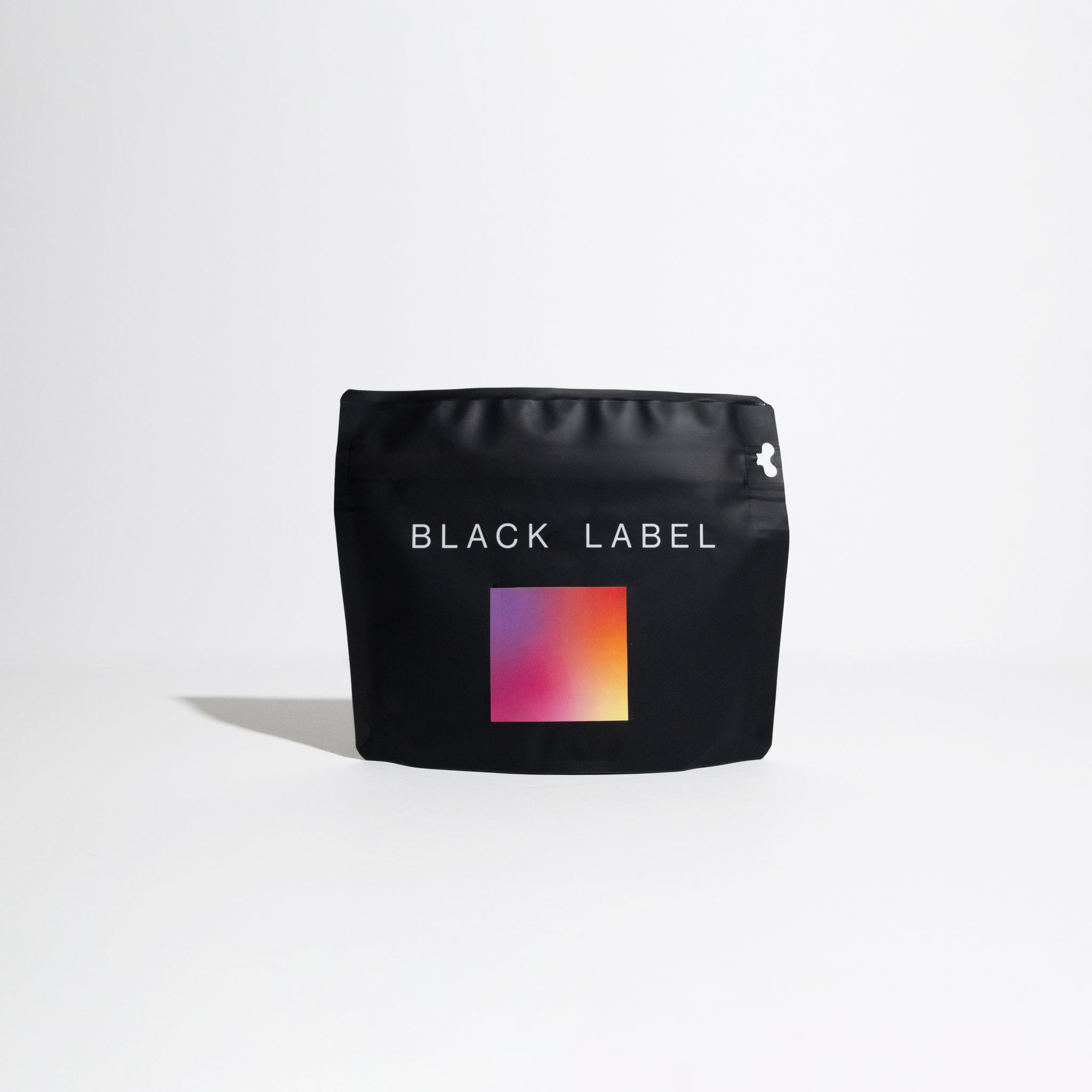Matte-black stand-up pouch labeled BLACK LABEL with a gradient graphic, representing Finca Deborah Interstellar Gesha coffee, known for its complex flavor profile.