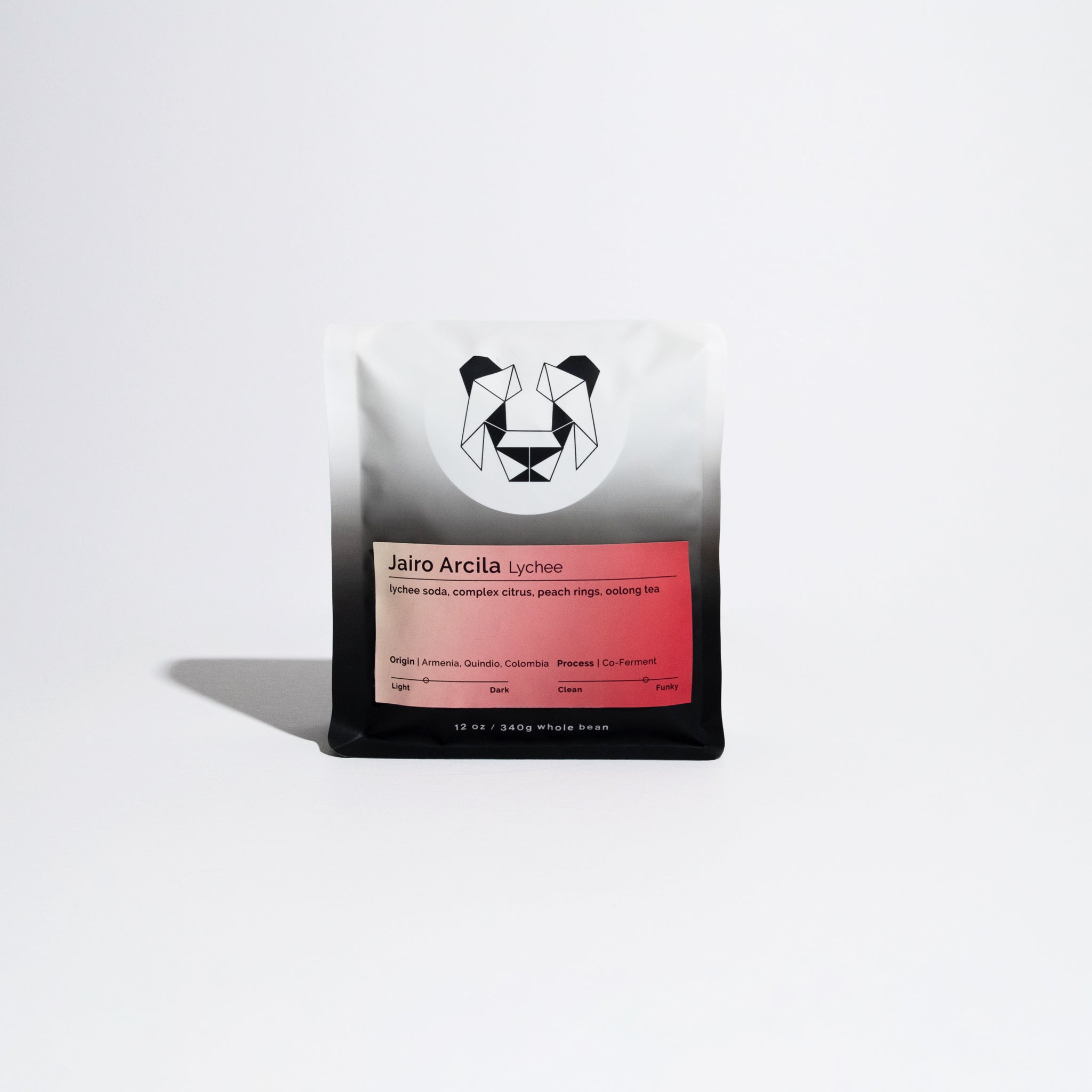 12 oz bag of Jairo Arcila Lychee whole-bean coffee, featuring a geometric bear logo and notes of lychee soda, citrus, and oolong tea.