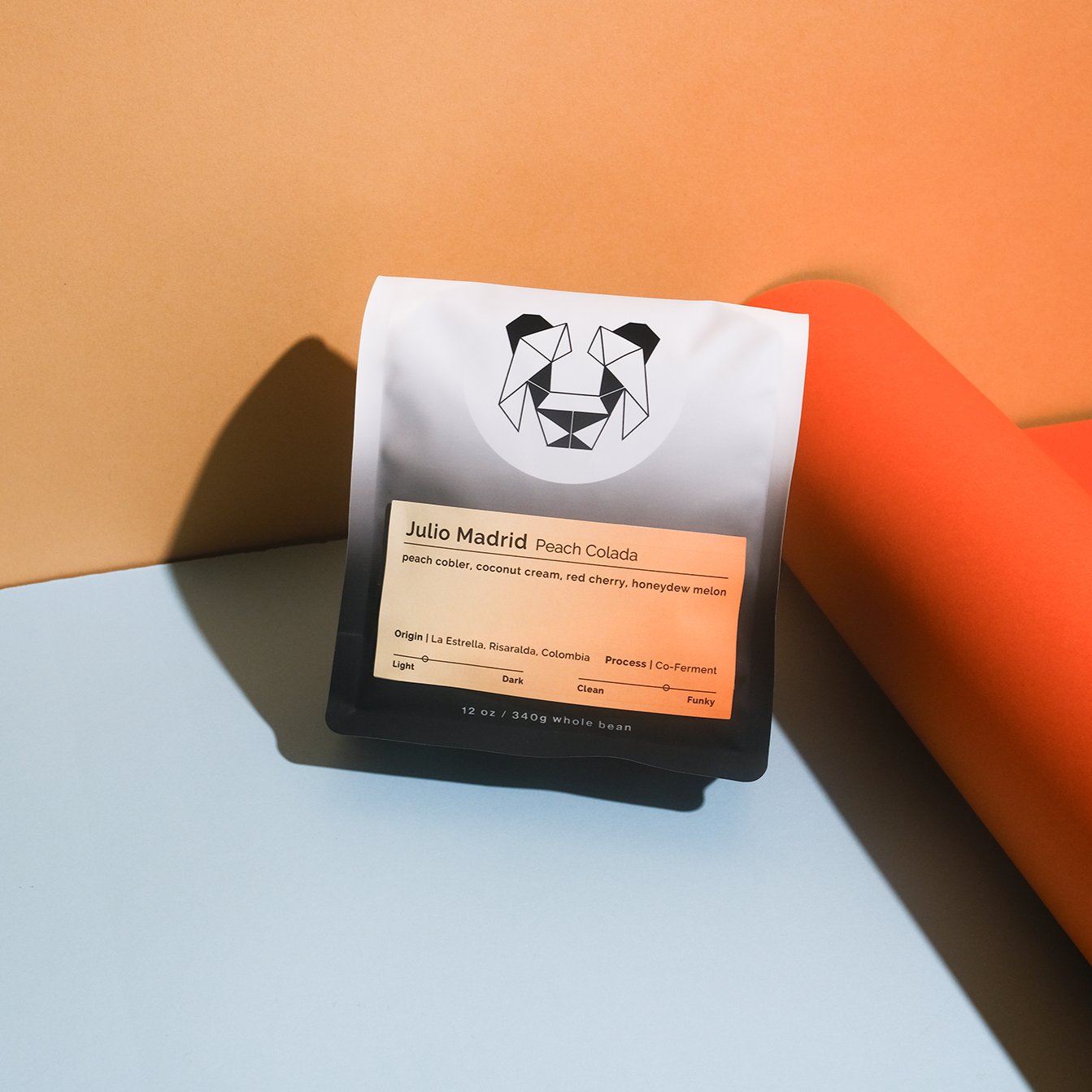 Julio Madrid - Peach Colada coffee blend, featuring Gesha beans co-fermented with peaches and coconut distillate, evoking peach cobbler and tropical flavors.