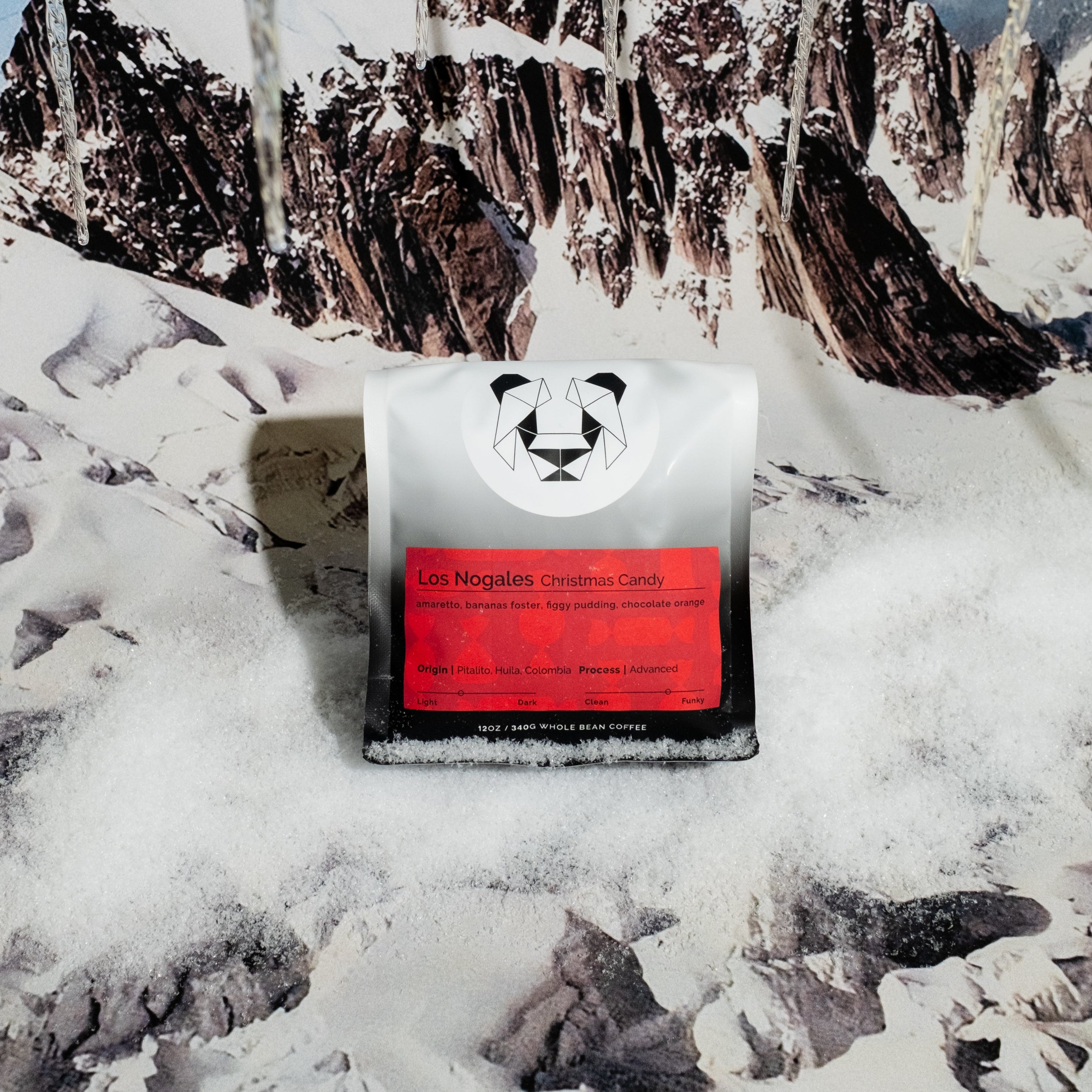 Los Nogales Christmas Candy bag of coffee on a snowy background.