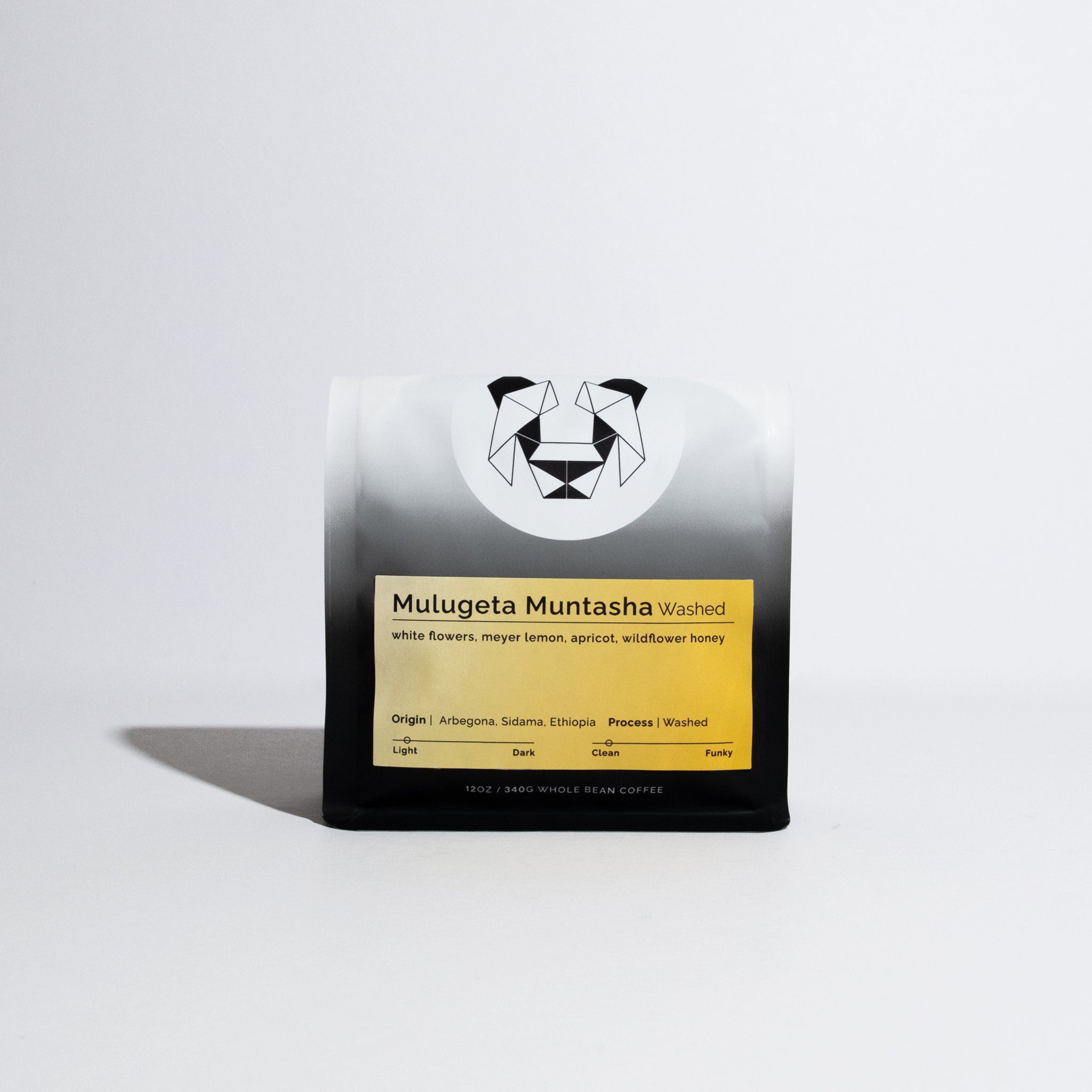 12 oz bag of Mulugeta Muntasha Washed whole-bean coffee, featuring tasting notes and origin from Arbegona, Sidama, Ethiopia, with a geometric animal logo.