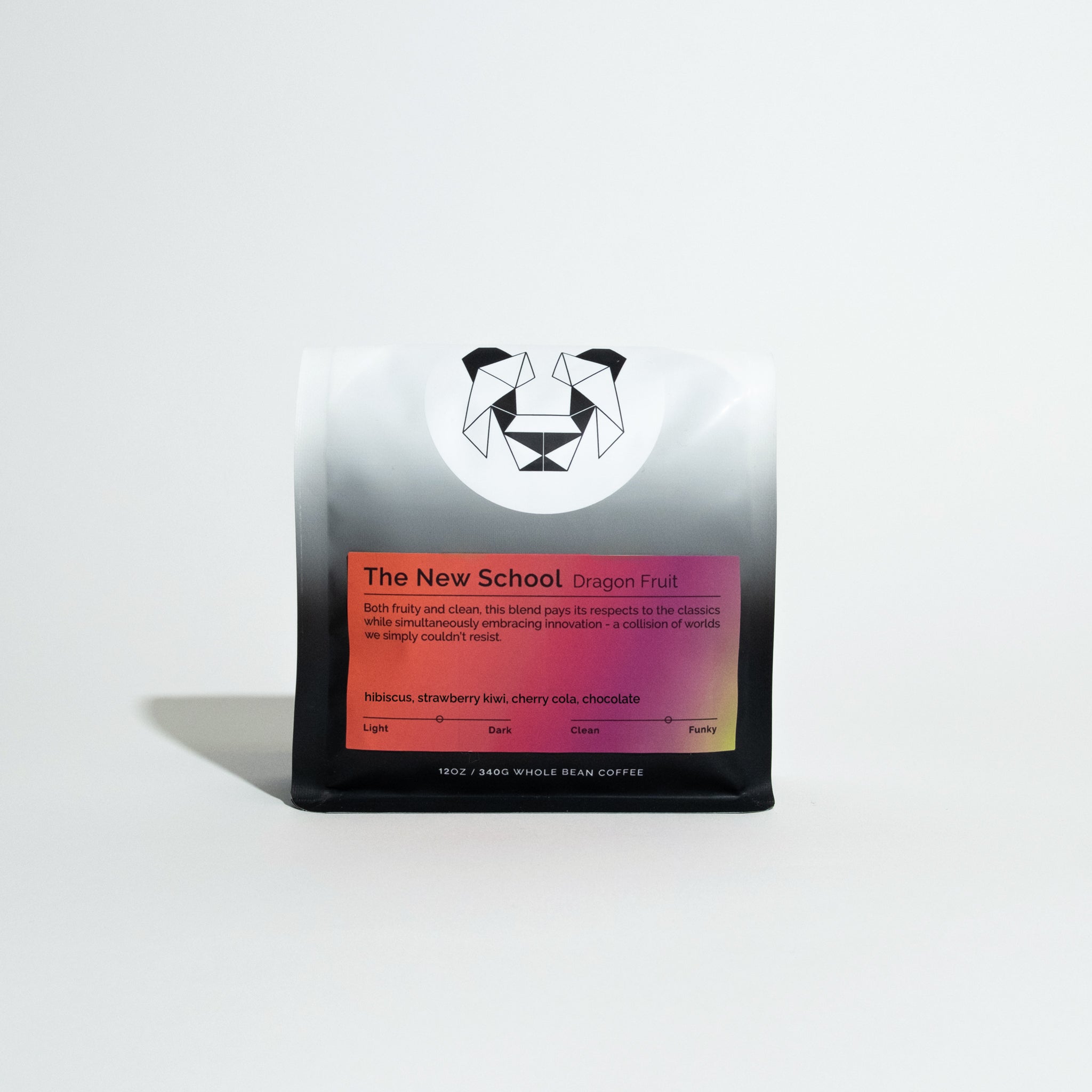 The New School's Dragonfruit blend, 12 oz whole-bean coffee, features a geometric panda-face logo and warm-gradient label with fruity tasting notes.