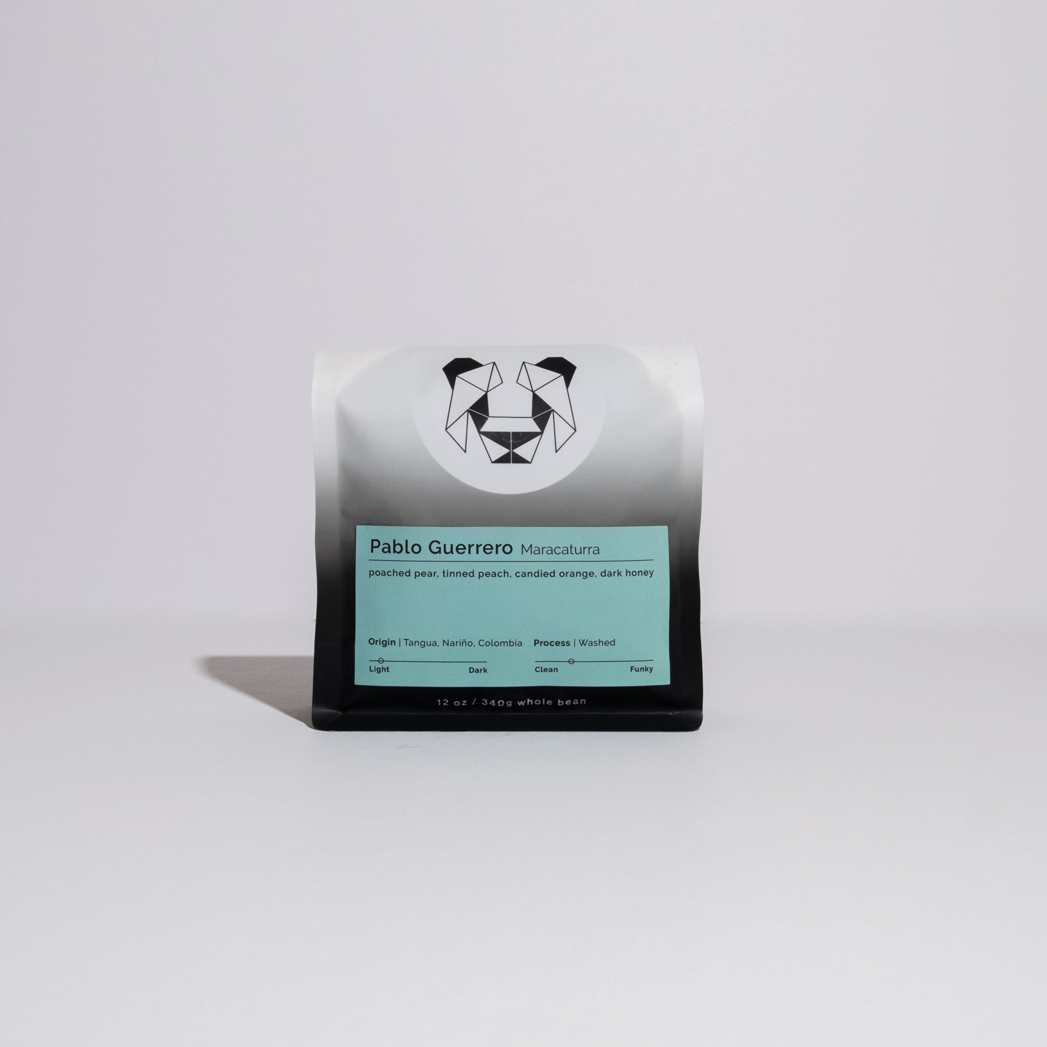 Pablo Guerrero - Maracaturra coffee bag on a white surface, featuring a blue card with text describing the producer's award-winning coffee and unique fermentation process.