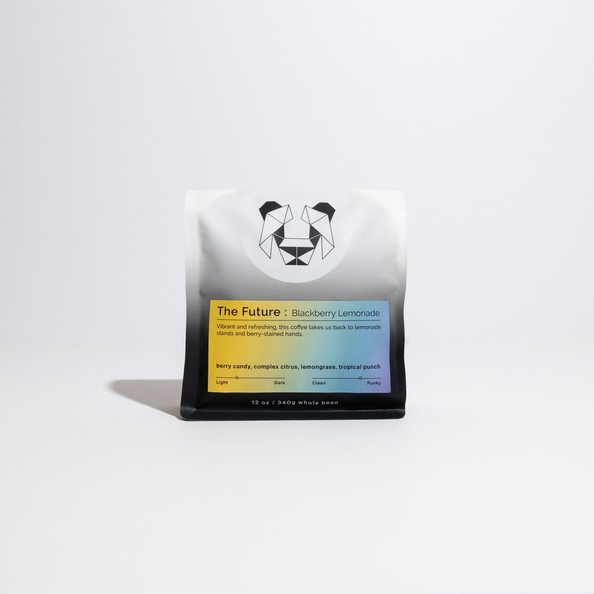 A coffee bag with a 45 degree angles gradient of honey yellow to a blue and purple right corner label on a white background with the words The Future : Blackberry Lemonade and tasting notes of berry candy, complex citrus, lemongrass and tropical punch. Coffee label says vibrant and refreshing, this coffee takes us back to lemonade stands and berry-stained hands with roast level light medium and very funky.