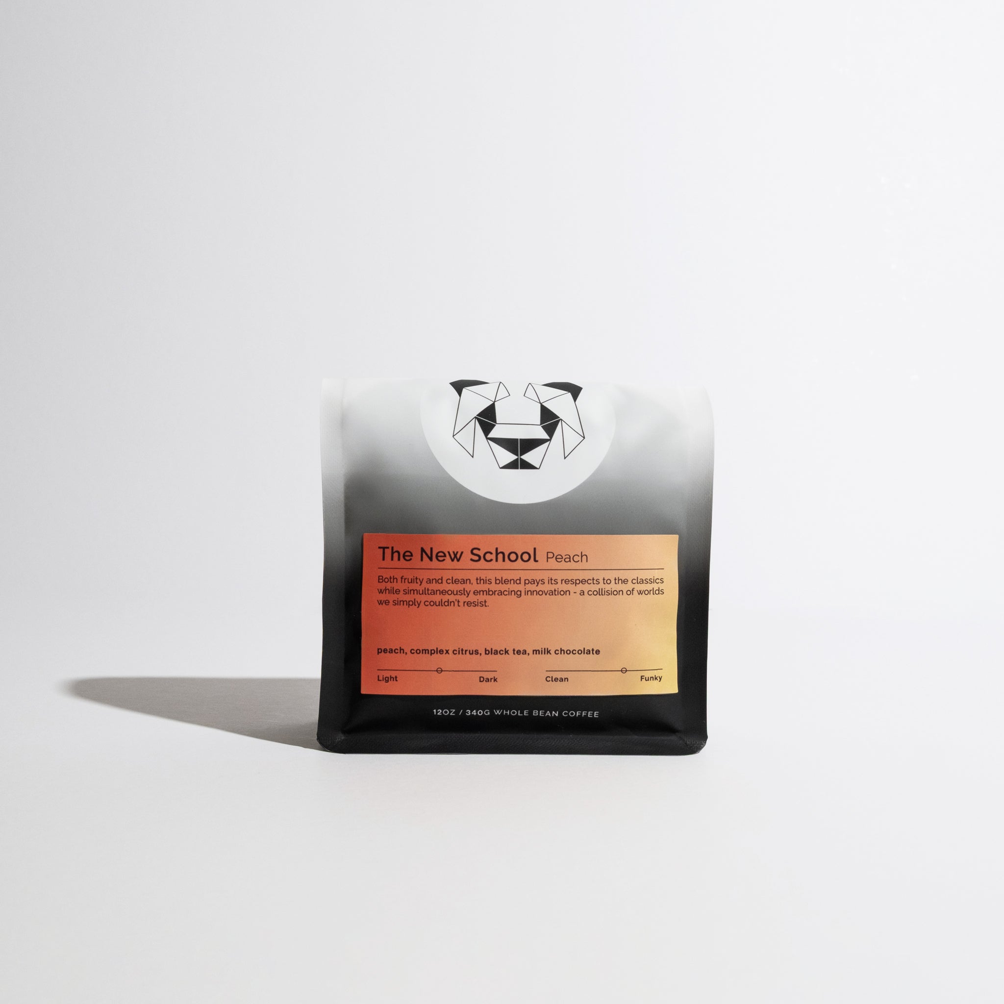 The New School Peach coffee bag, 12 oz, features a matte finish, geometric logo, and orange-peach gradient label, highlighting its peach and citrus tasting notes.