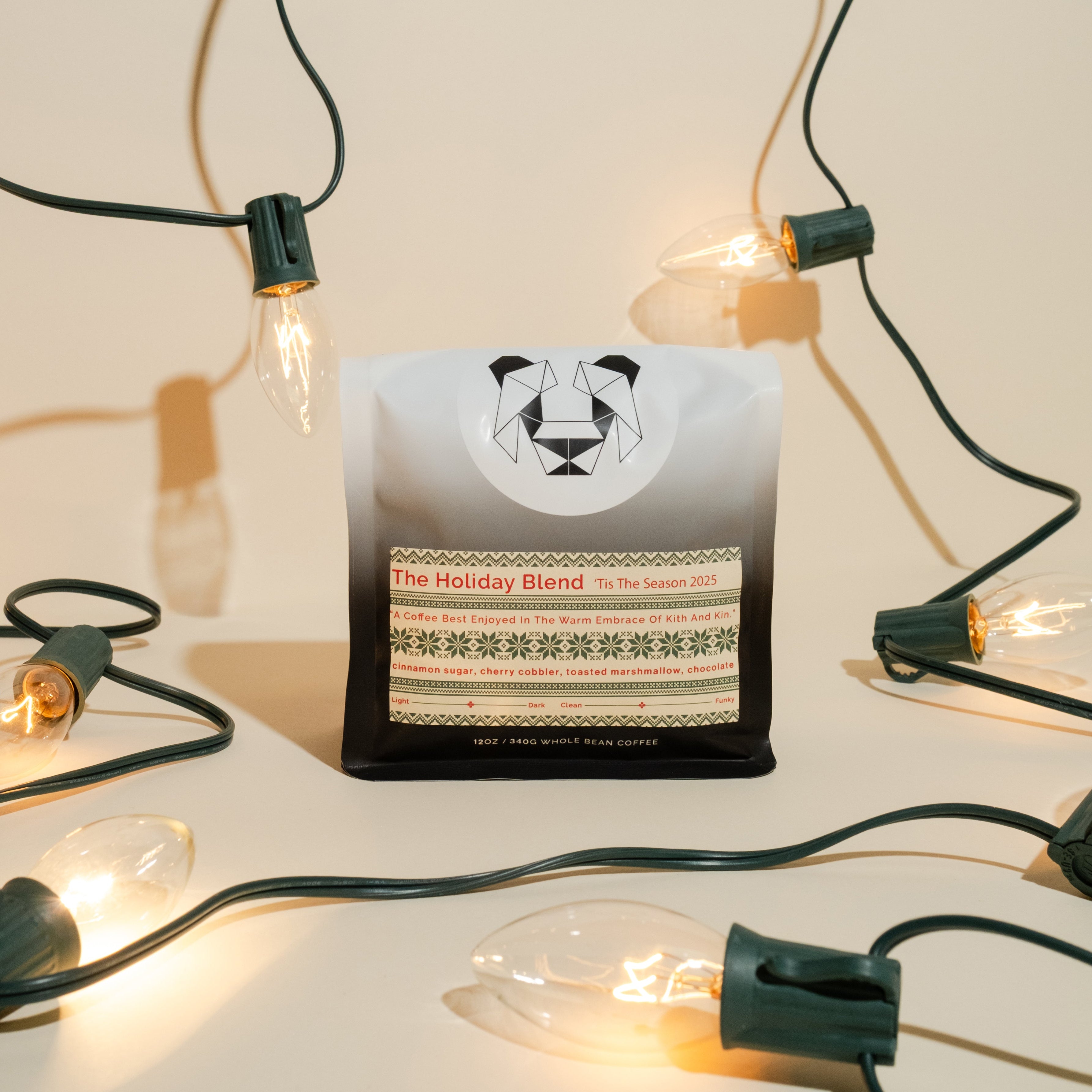 The Holiday Blend coffee on a holiday themed backdrop with lights.