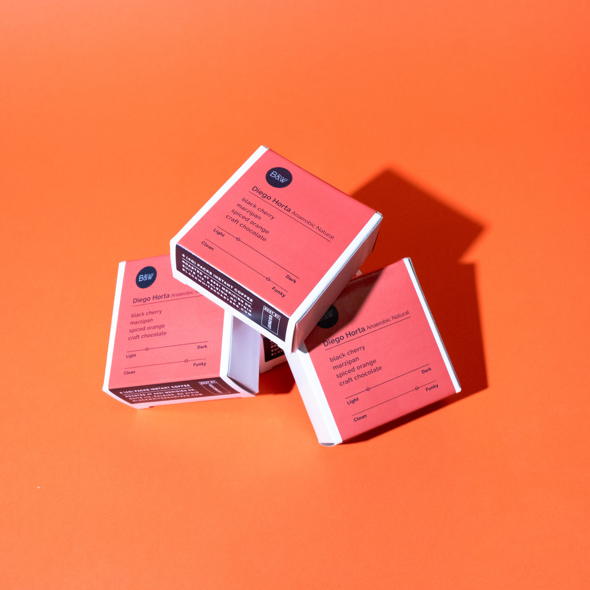 3 instant boxes of Diego Horta - Anaerobic Natural stacked on top of each other with a orange background.