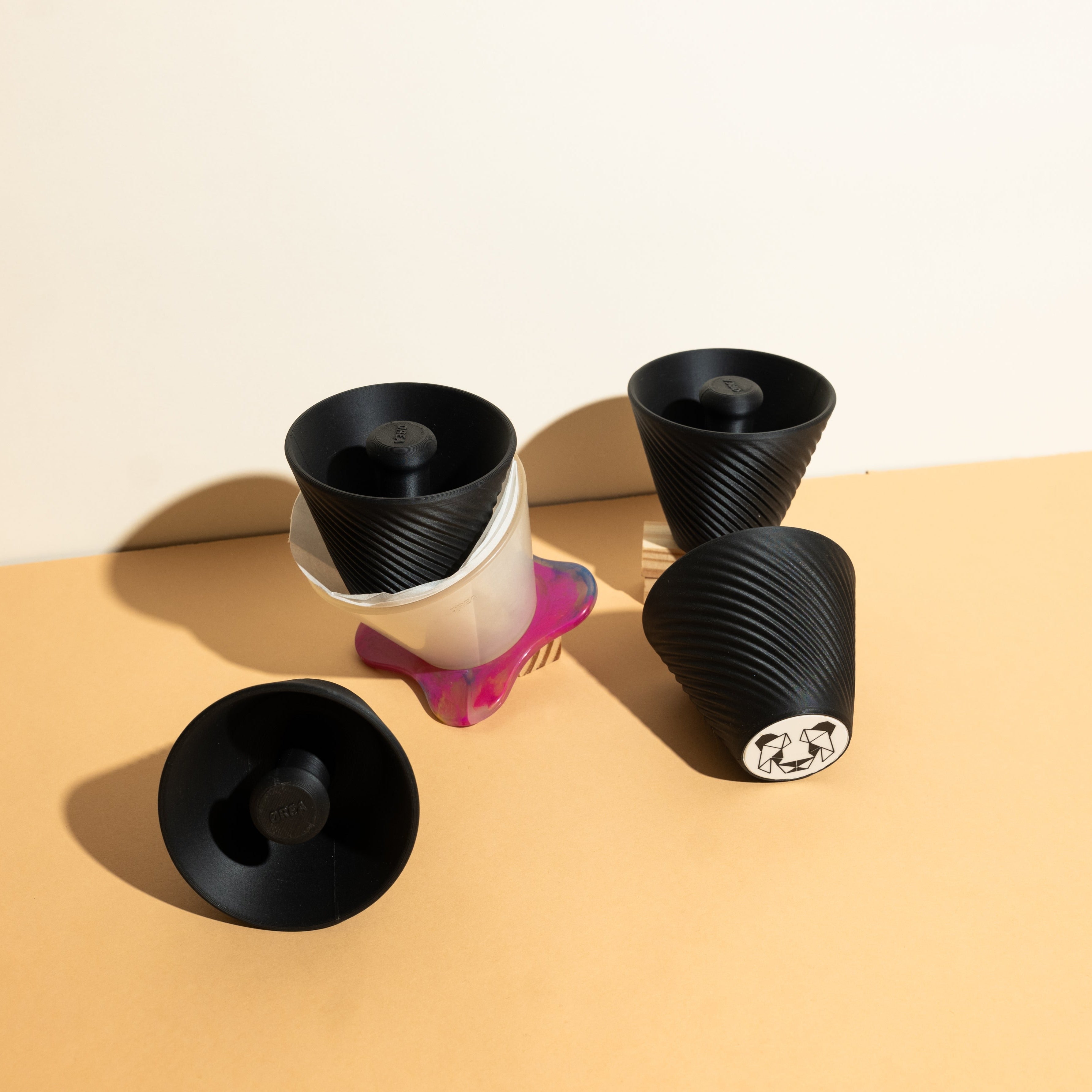 Pandagotiator accessory for Orea V3 dripper, featuring a compact, precise filter setting die, made from Galaxy Black PLA, designed for repeatable flat-bottomed filter brewing.