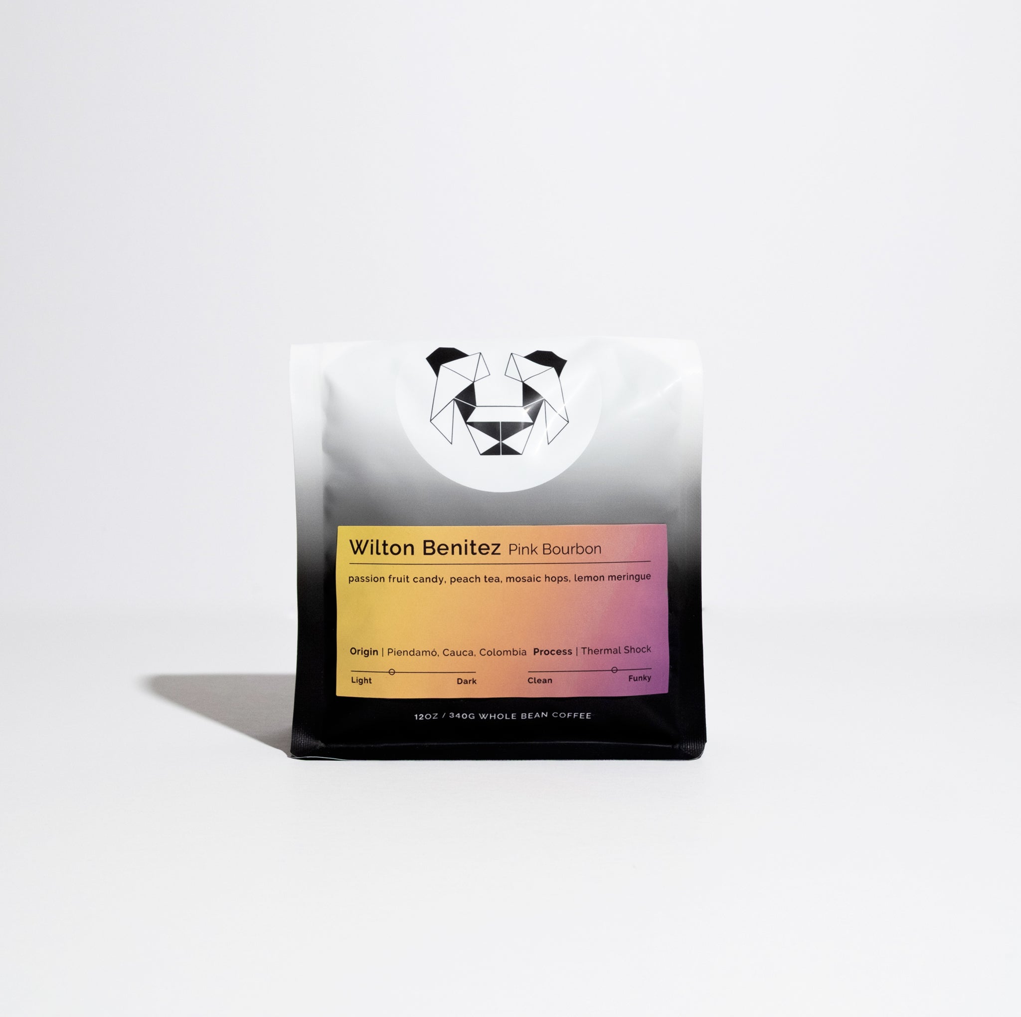 Wilton Benitez – Pink Bourbon coffee pouch featuring a geometric bear logo, colorful label with tasting notes, and origin details on a white-to-black gradient bag.