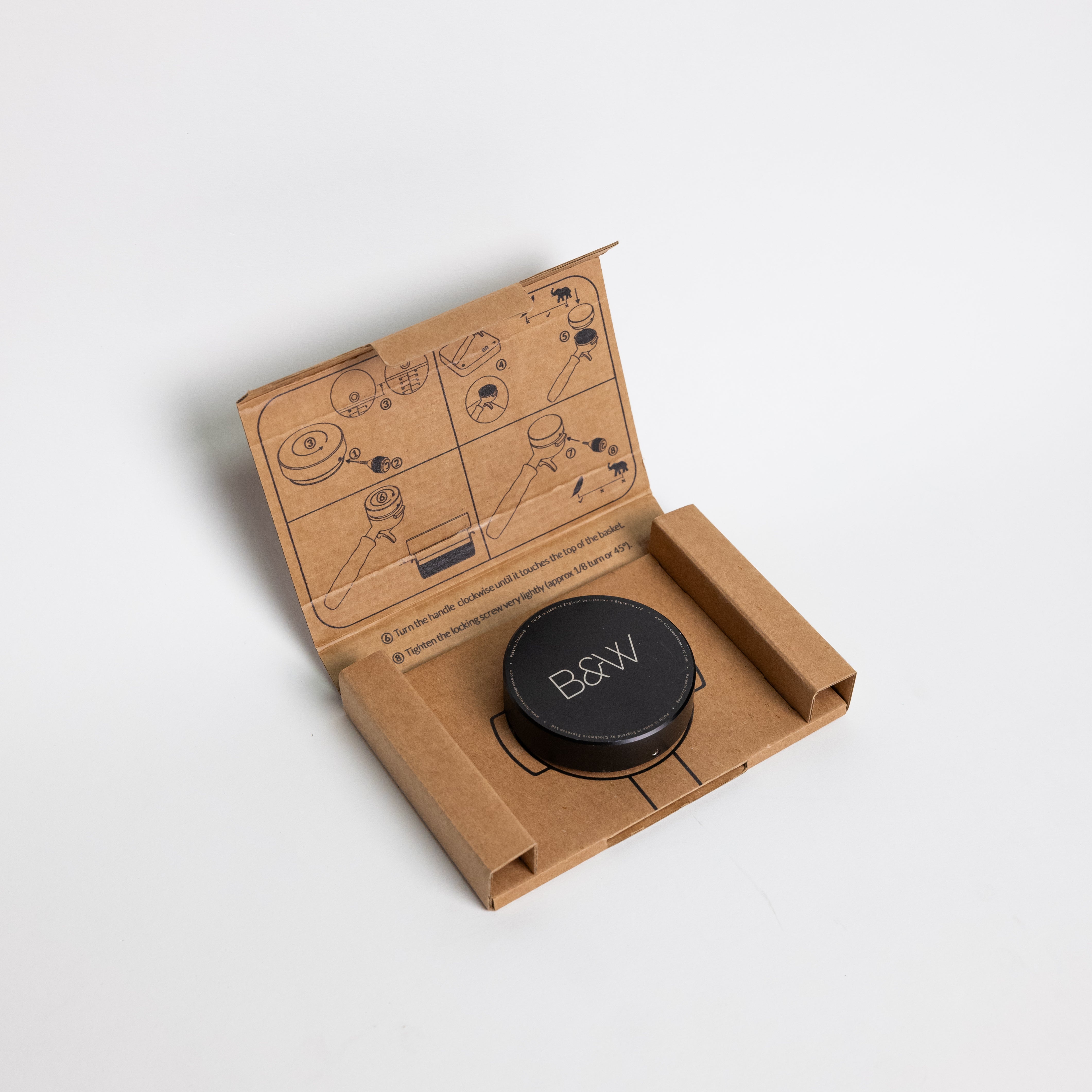 PUSH Adjustable Depth Tamper made of anodized aluminum and stainless steel, featuring a unique puck shape with included adjustment tool for precise coffee tamping.