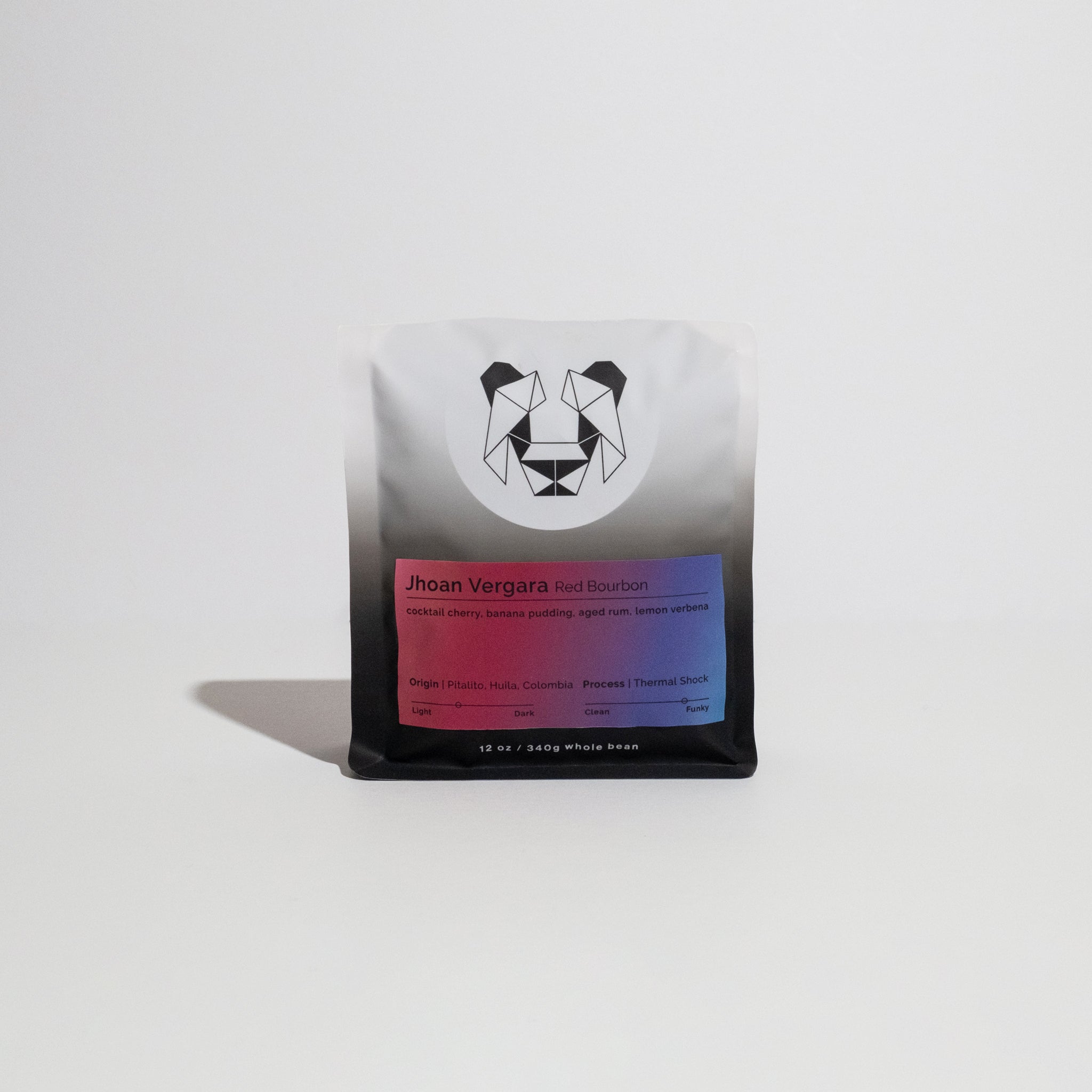 Jhoan Vergara - Red Bourbon coffee beans, showcasing unique processing methods like thermal shock, originating from Las Flores farm in Colombia. Vibrant and fruit-forward.