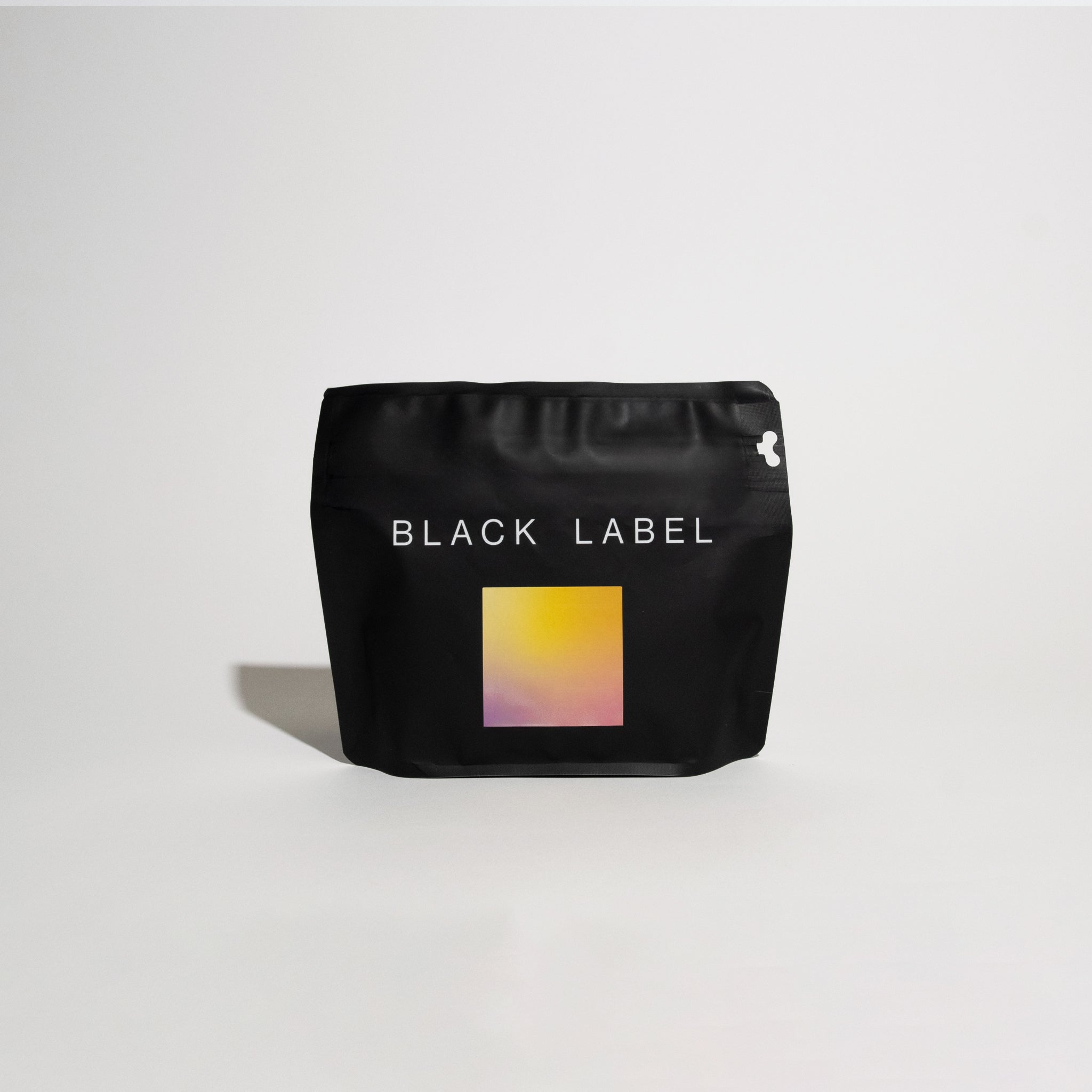 Matte-black pouch labeled BLACK LABEL with gradient graphic, representing R - Benjamin Paz 4x - Gesha, a Honduran specialty coffee by Benjamin Paz.