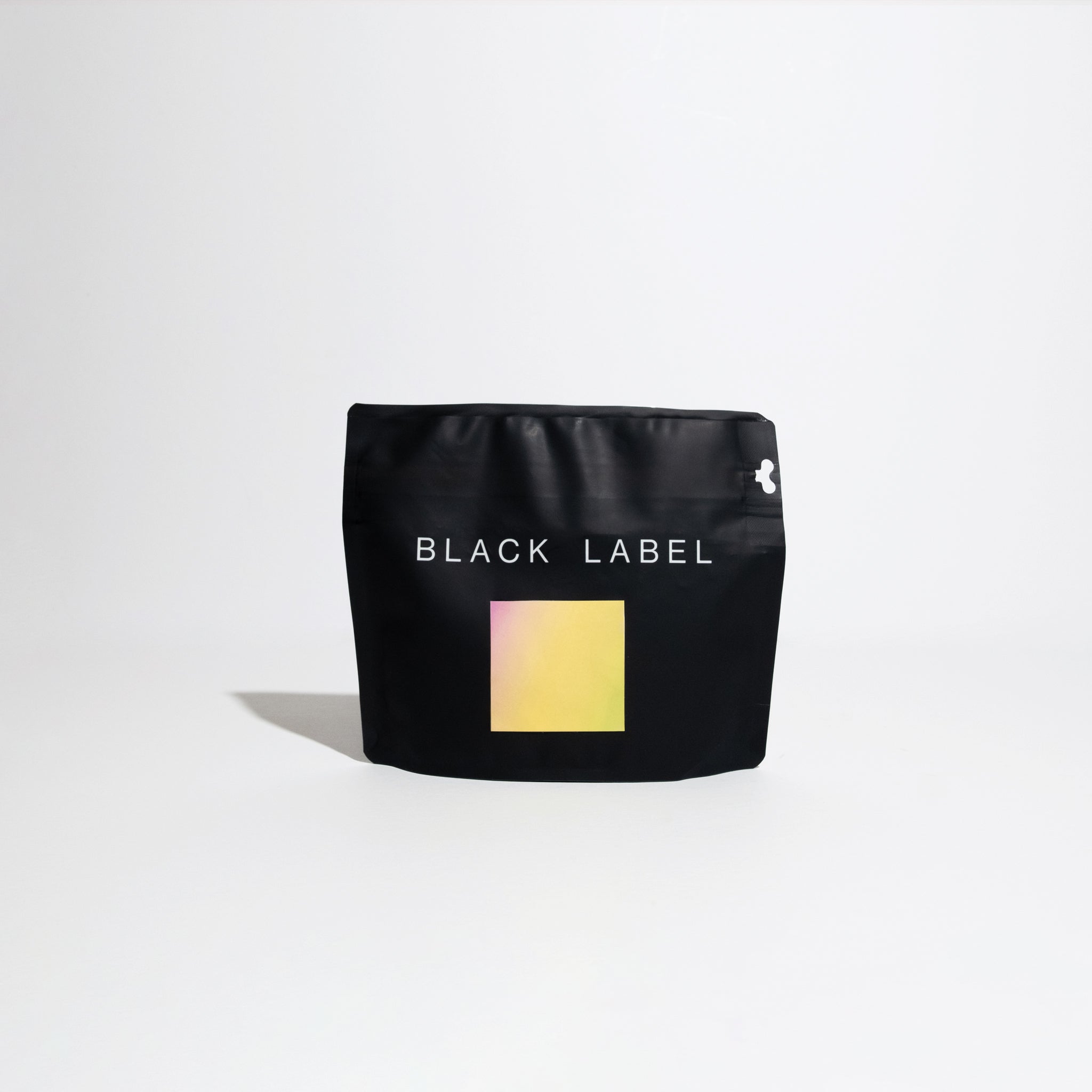 Black bag featuring a yellow label, representing the Benjamin Paz - Anaerobic Washed coffee, highlighting its unique fermentation process and exquisite flavor profile.