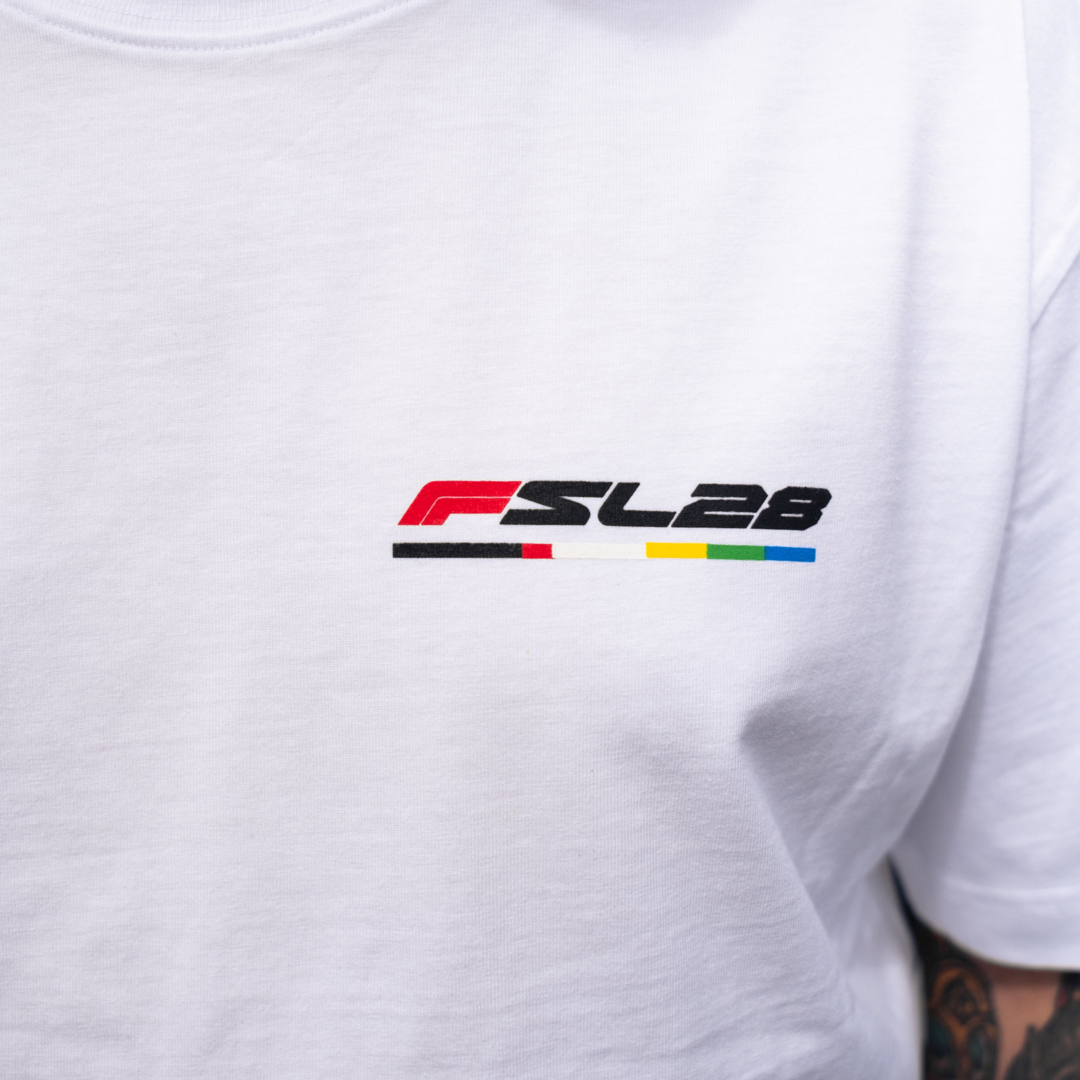 Close-up of the Color Bar Birthday Shirt featuring the FSL28 logo and colorful stripe design on the chest, highlighting its connection to innovative coffee culture.