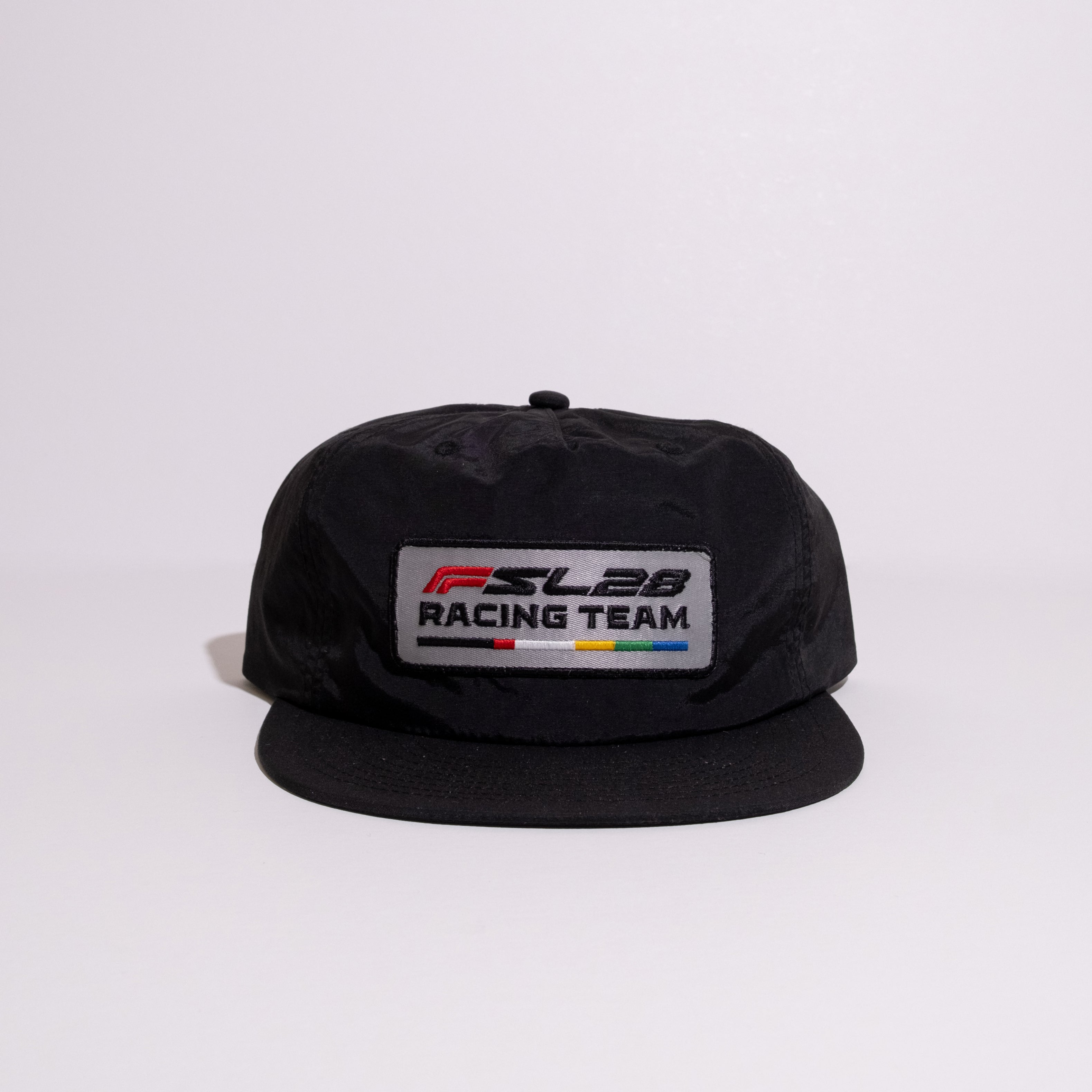 FSL28 Racing Team Hat with embroidered patch, featuring colored bars. Black baseball cap with flip-up buckram, flat visor, and adjustable snapback.