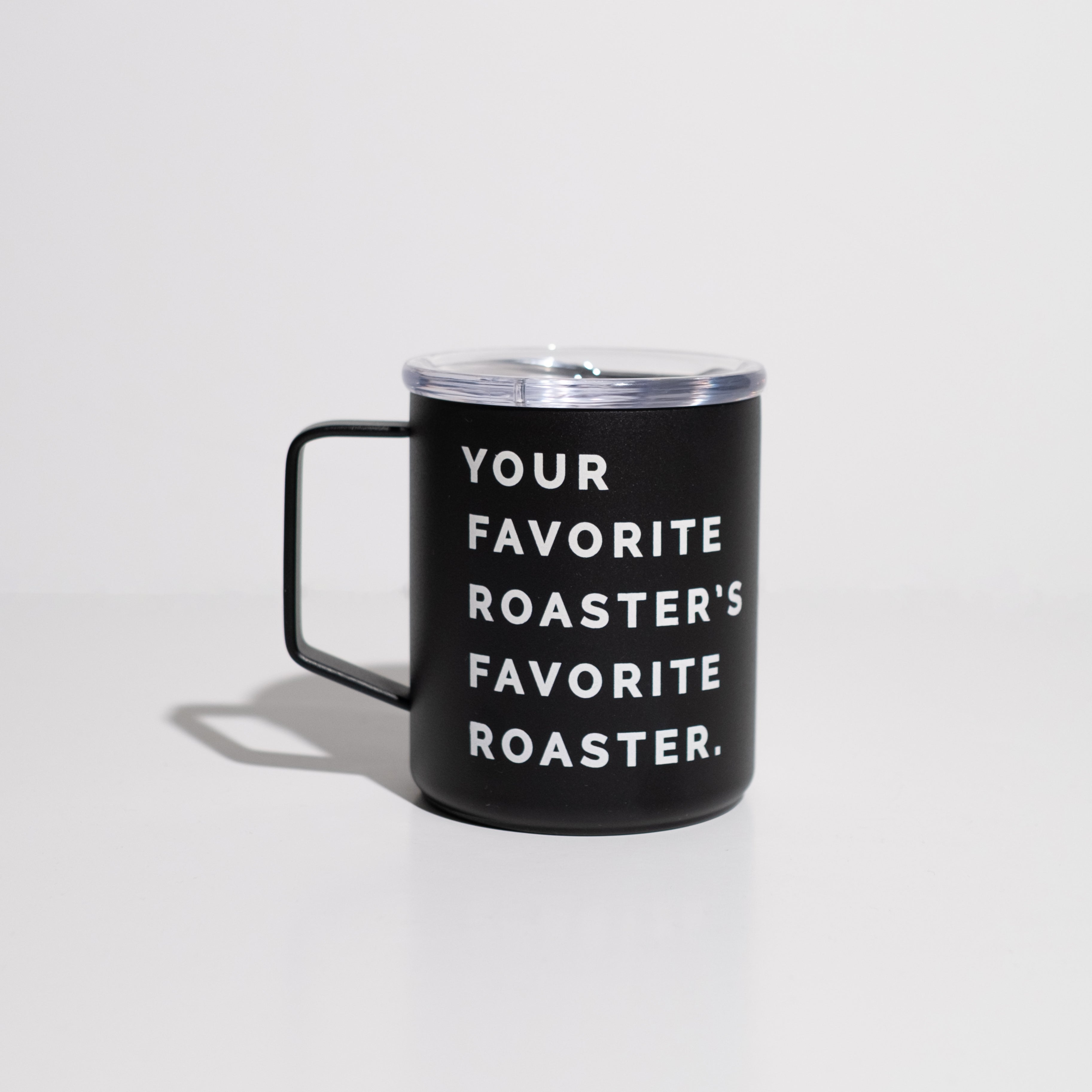 An enamel 12 ounce Camp cup that is black with white lettering that says, your favorite roaster favorite roaster. Cup is situated on white background.