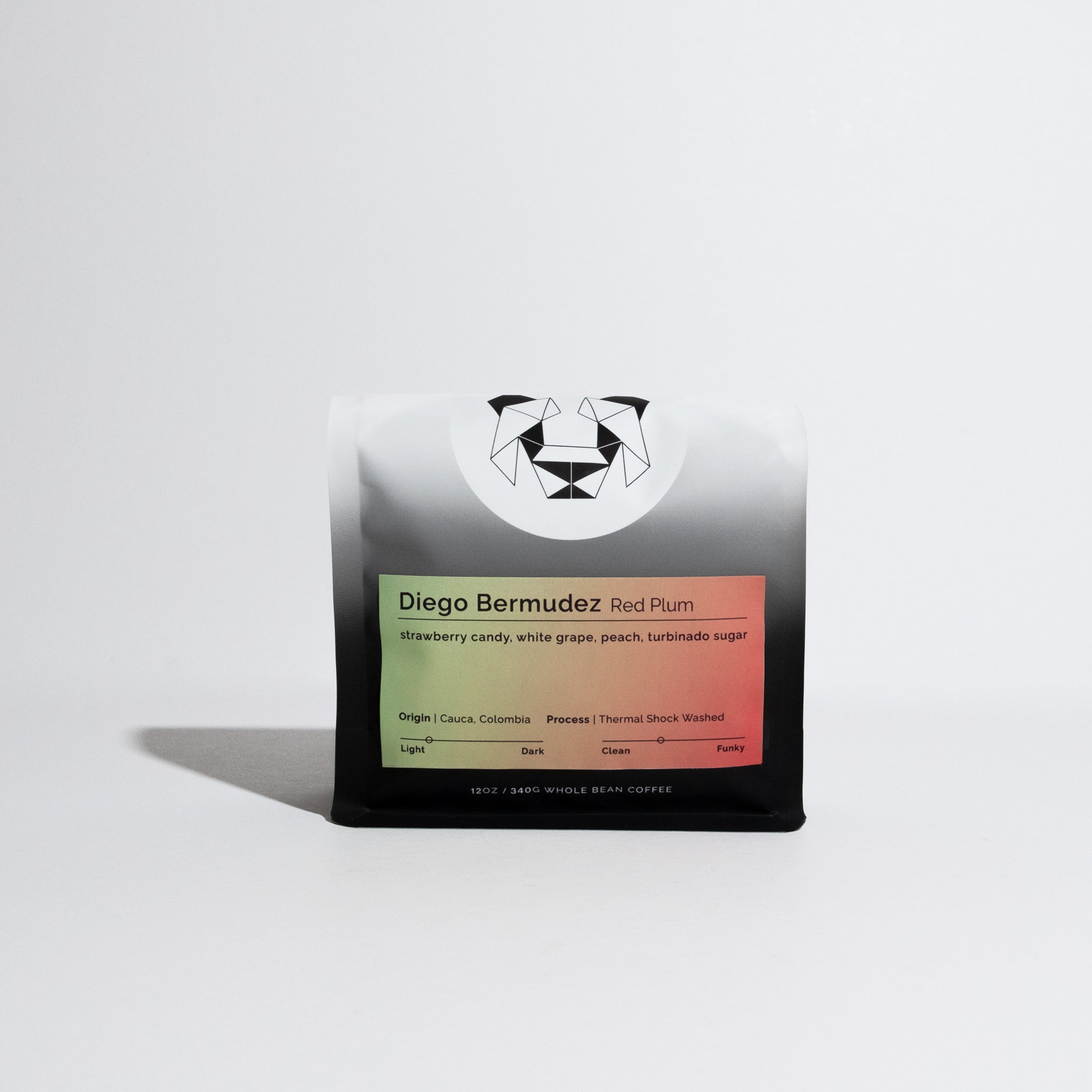 Bag of whole-bean coffee labeled Diego Bermudez Red Plum, showcasing strawberry candy, white grape, and peach notes, with origin in Cauca, Colombia.