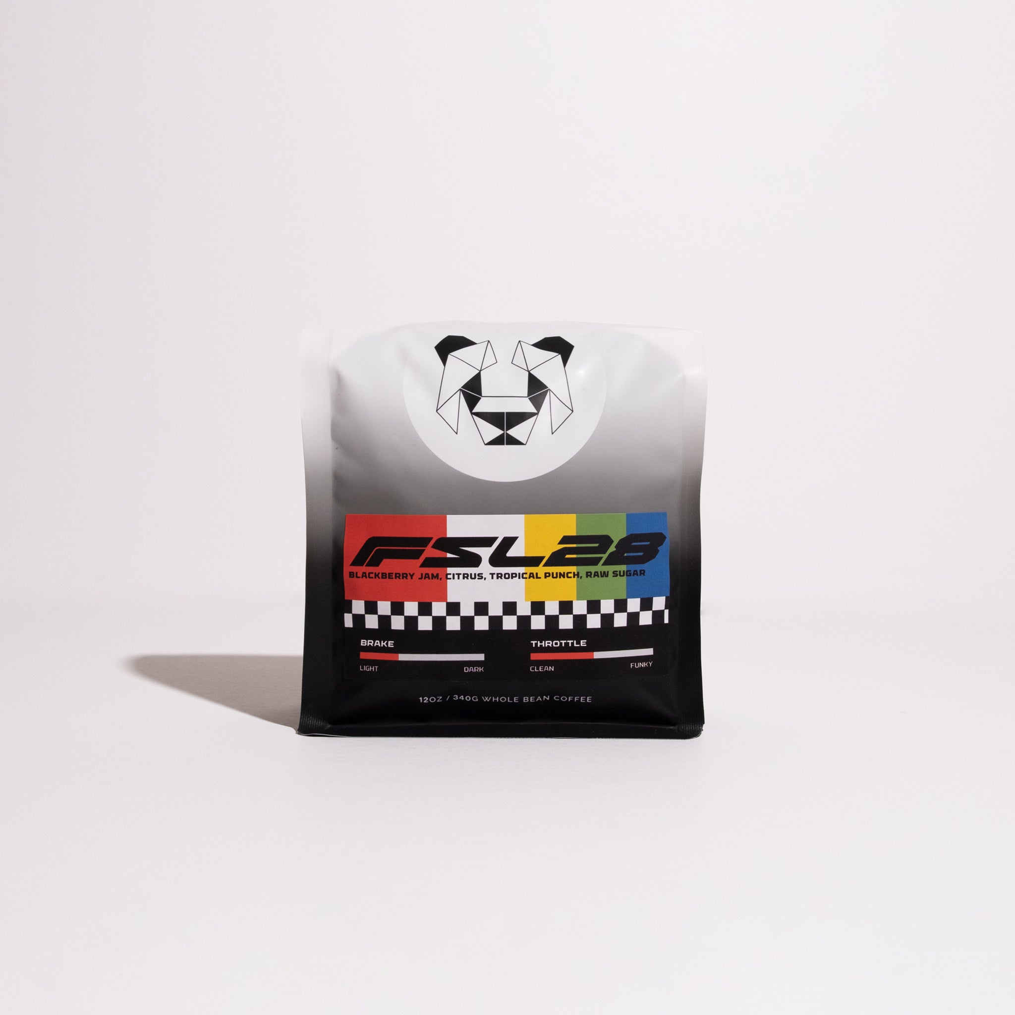 Bag of Formula SL28 whole-bean coffee with geometric animal logo, checkered stripe, and label listing tasting notes of blackberry jam, citrus, and tropical punch.