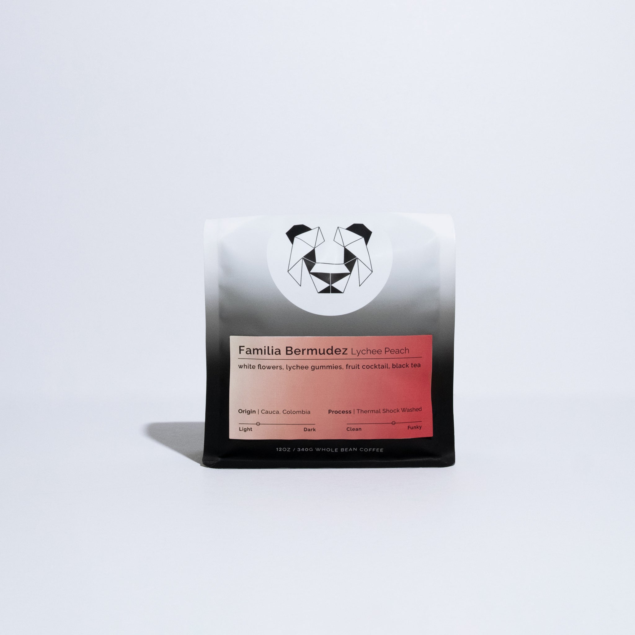 A single bag of Familia Bermudez Lychee Peach whole bean coffee, featuring a white and black gradient bag with a red label, set against a clean white background.