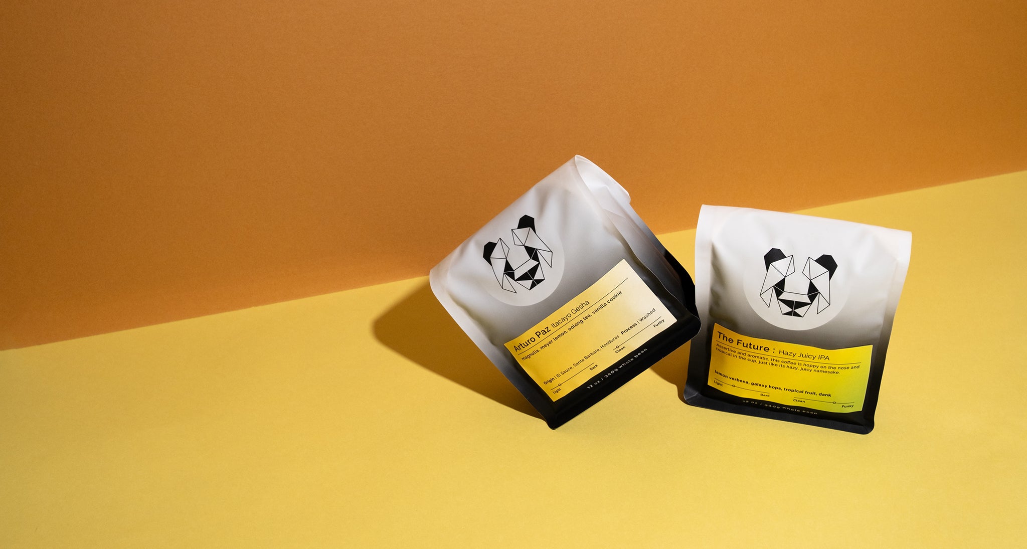 Two Bags of Coffee On a colored background. One label says Arturo Paz Itacayo Gesha with notes of magnolia, lemon, oolong tea, and vanilla cookie. The other coffee has a label that says the future hazy juicy IPA with notes of lemon verbena, galaxy hops, tropical fruit and dank.
