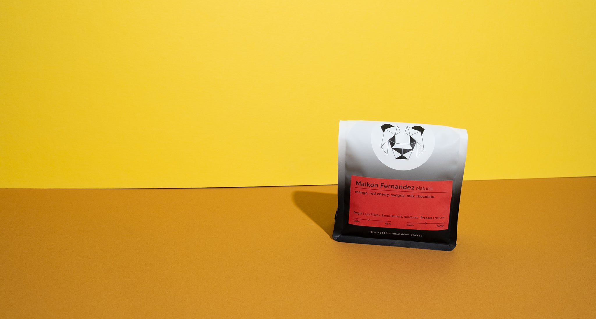 A bag of coffee on a colorful background with a solid color label that says Maikon Fernandez natural.