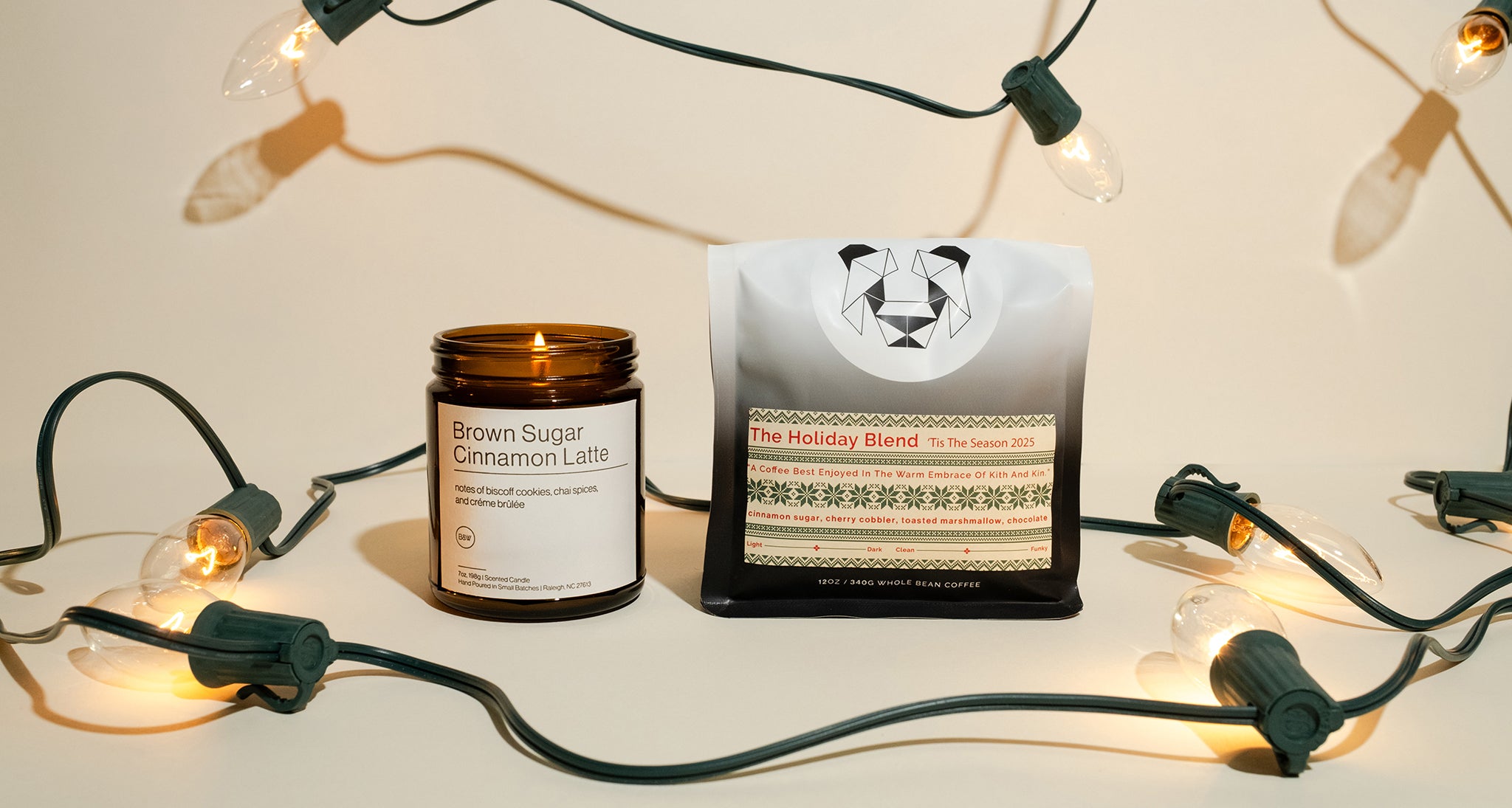 HolidayBlend COffee and brown sugar cinnamon latte candle on a cream backdrop with lights.