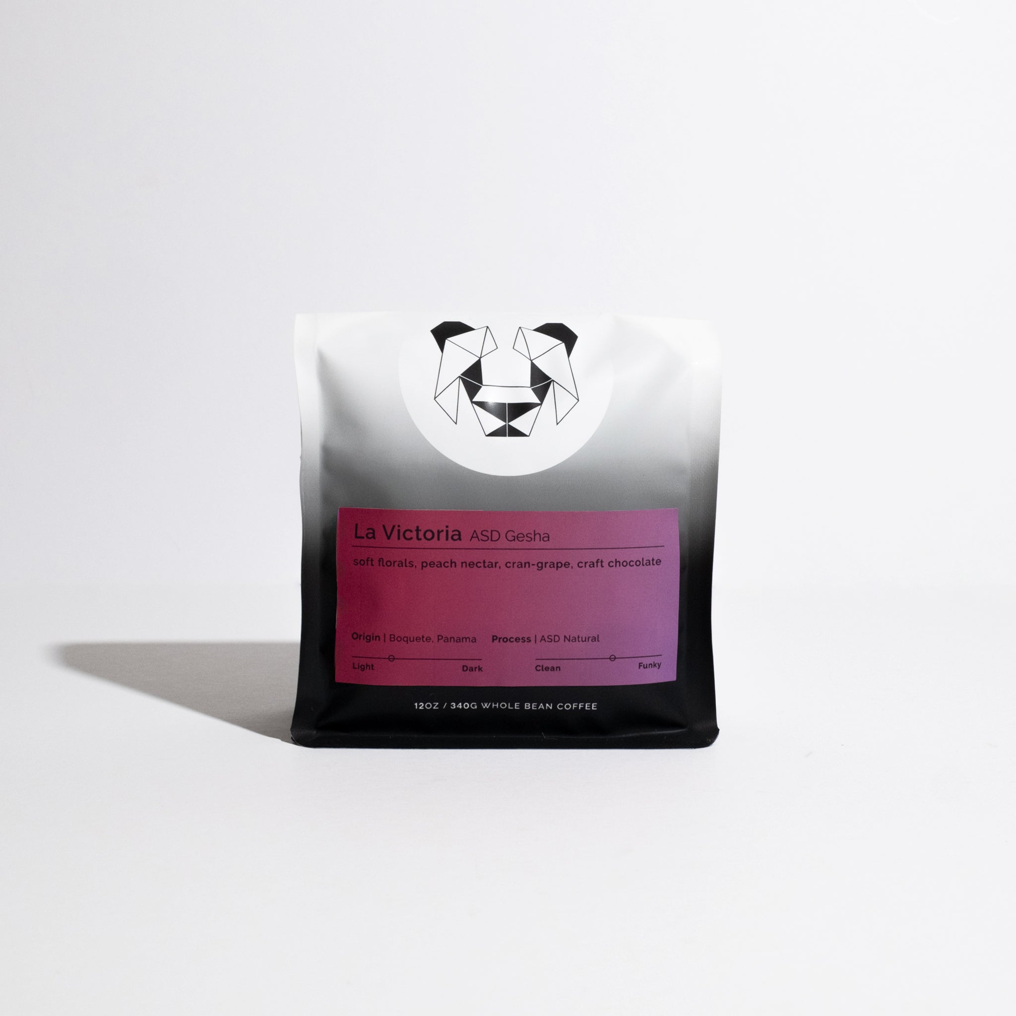 La Victoria ASD Gesha coffee bag, featuring a geometric panda, highlights tasting notes: soft florals, peach nectar, cran-grape, craft chocolate. Origin: Boquete, Panama.