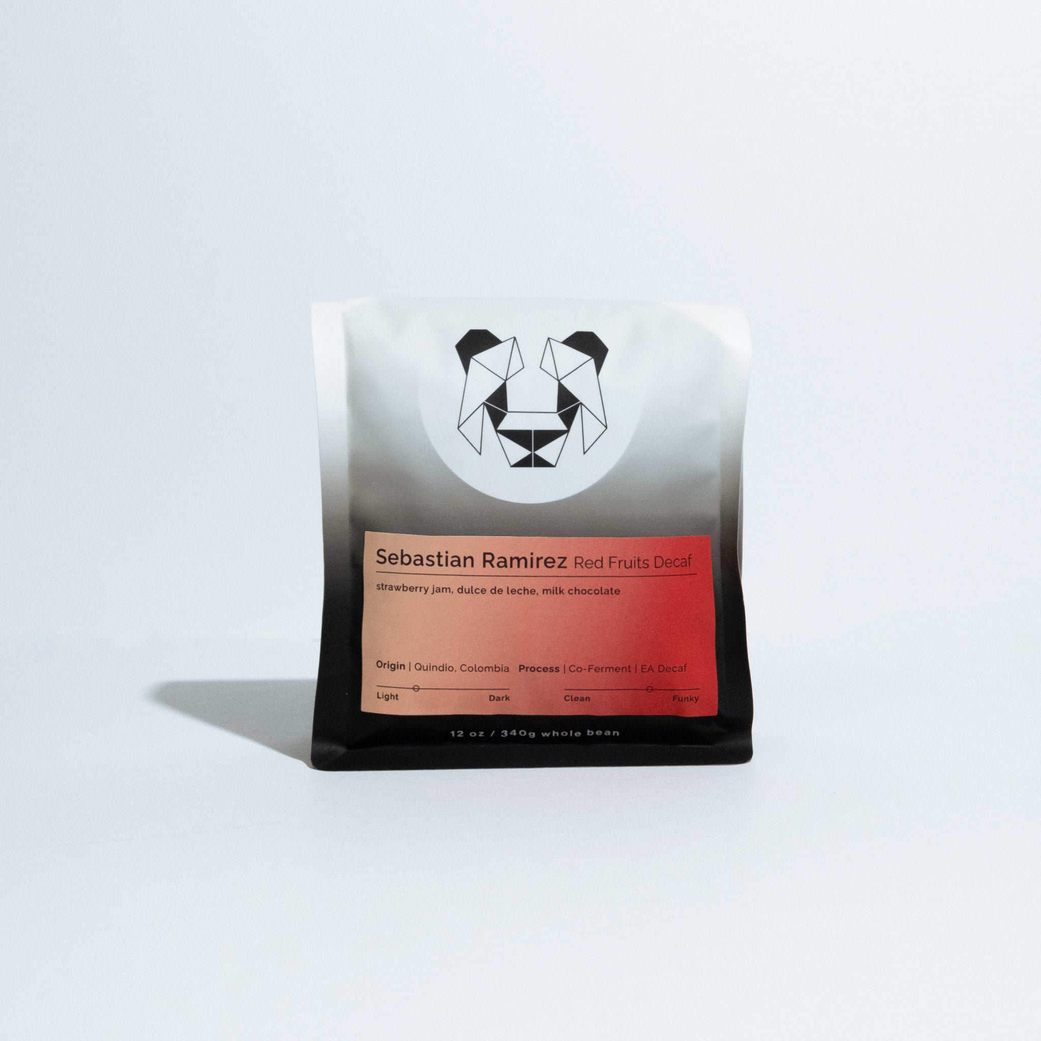 A single coffee bag from Sebastian Ramirez, featuring a white-to-black gradient package with a geometric panda logo and a red-orange label, photographed on a clean white background.
