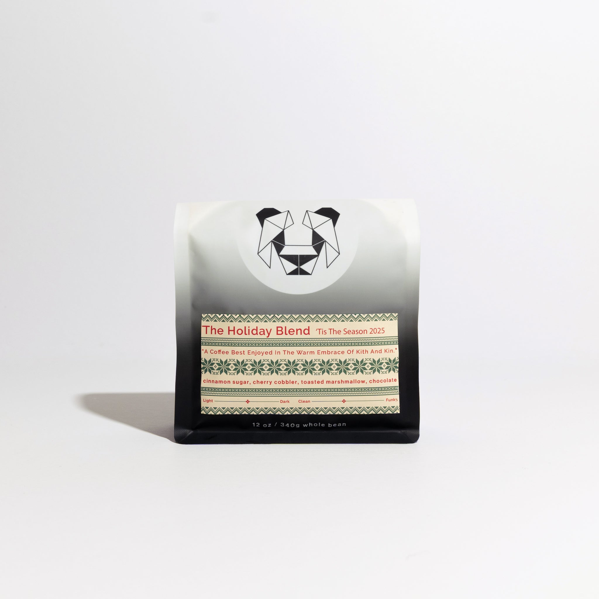 A bag of coffee on a white background with a christmas sweater themed label that says The Holiday Blend - 'Tis The Season 2025 on it. 