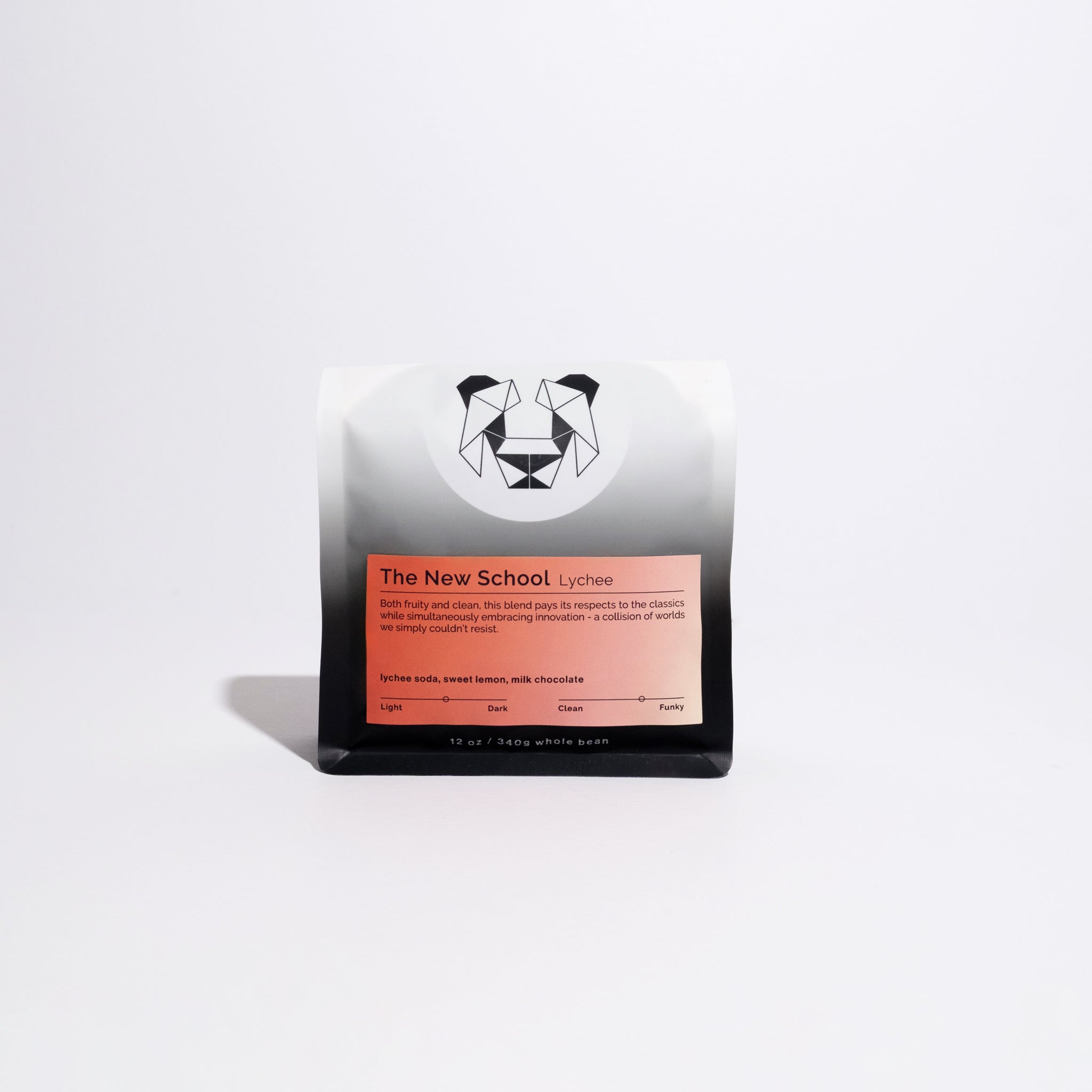 12 oz bag of The New School's Lychee blend whole-bean coffee, featuring a geometric logo, orange label, and tasting notes: lychee soda, sweet lemon, milk chocolate.