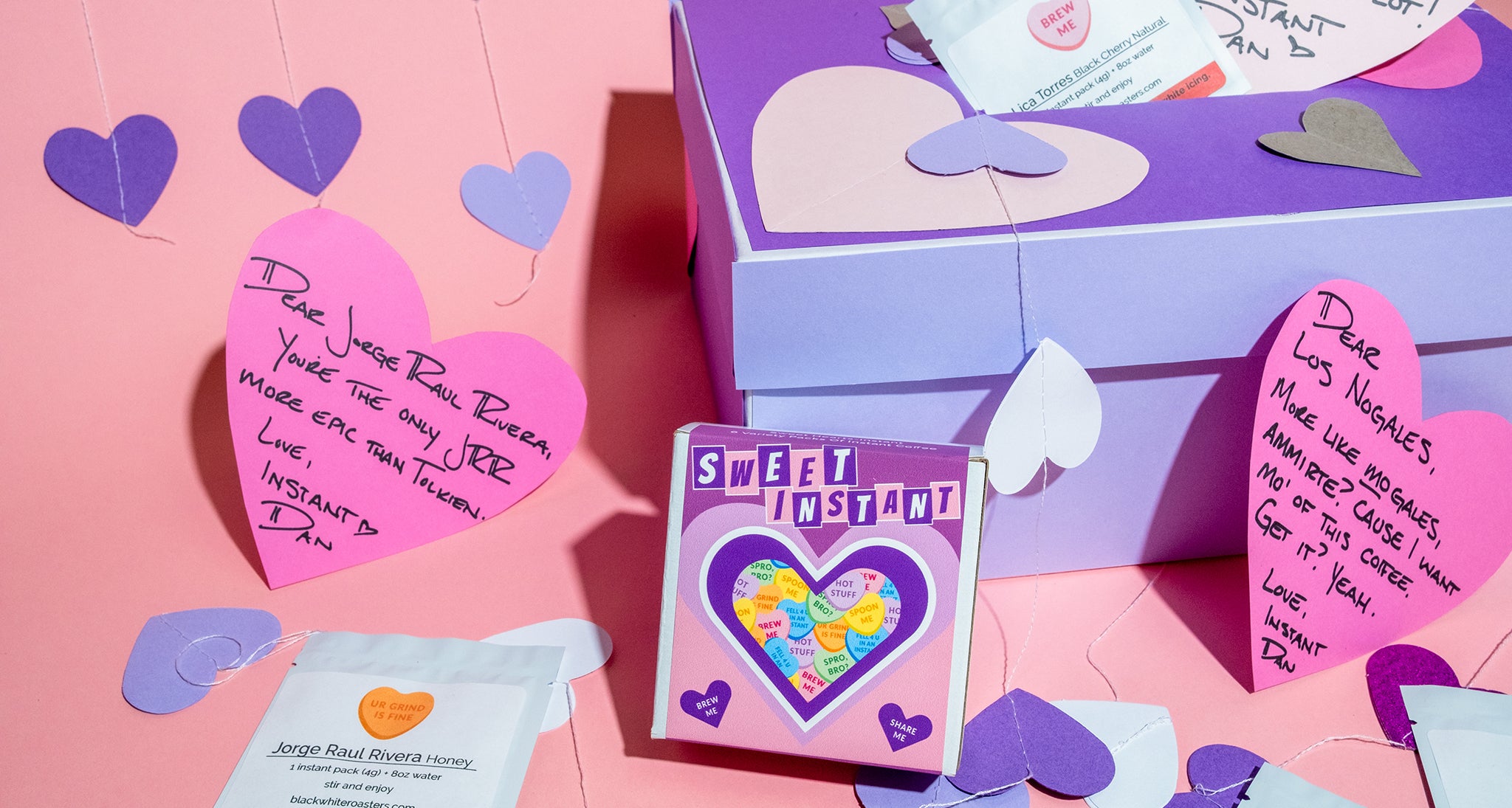 Product packaging with heart-shaped notes and confetti on a pink background